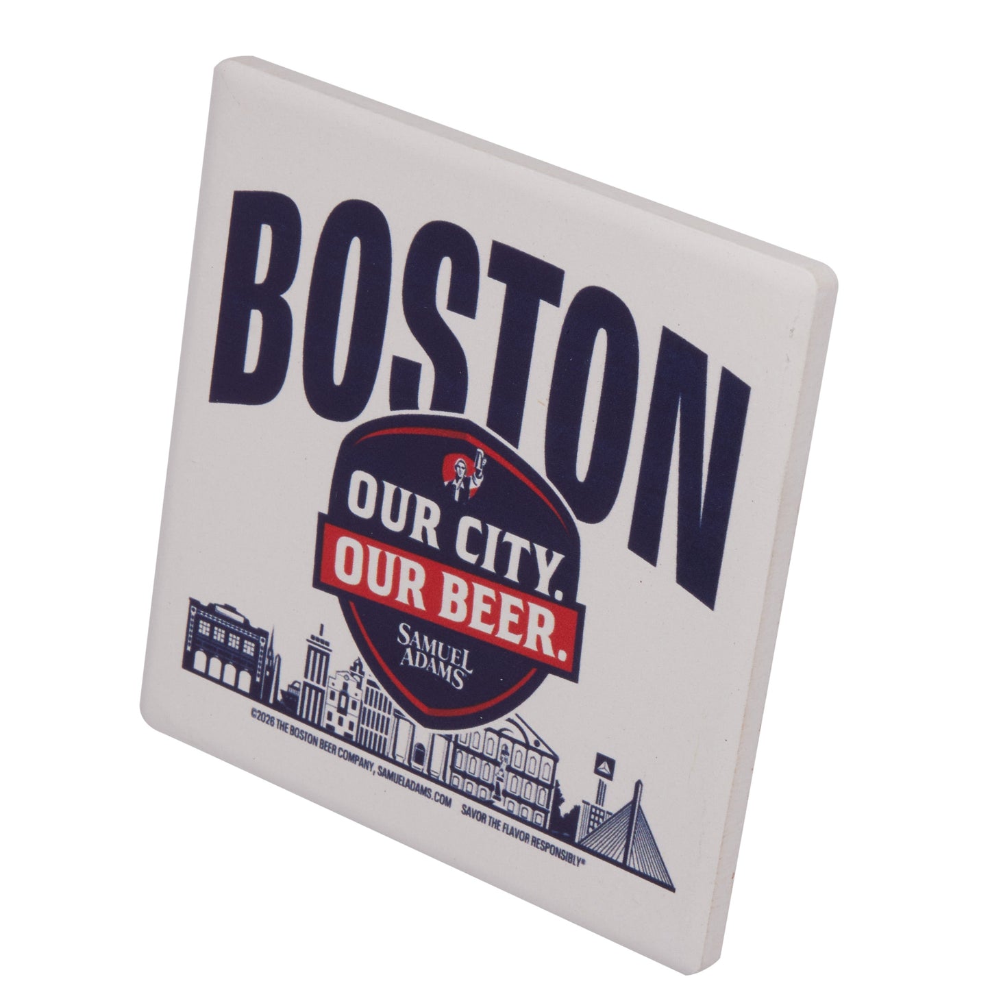 Angled view of Boston “Our City Our Beer” coaster by Samuel Adams, showcasing bold Boston lettering and skyline graphic on a square drink coaster.