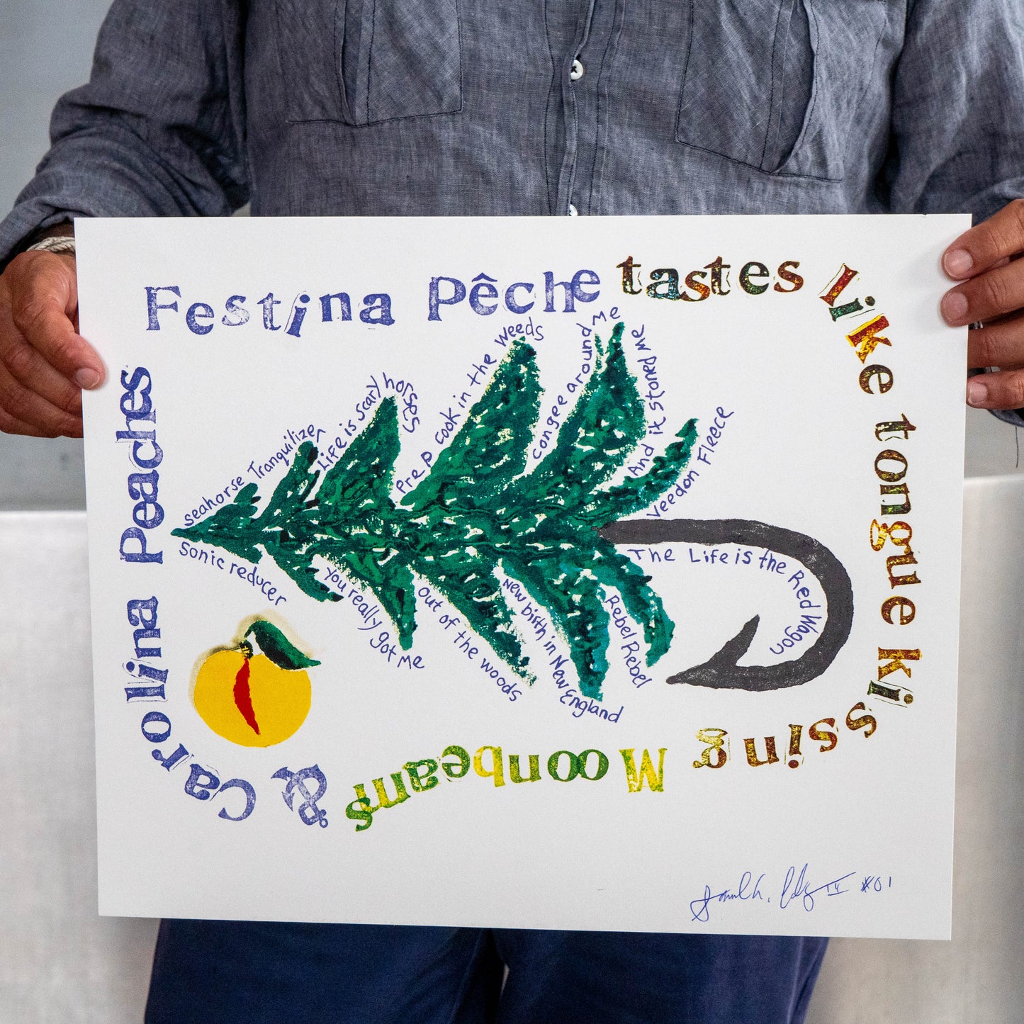 Signed Festina Peche screen print poster being held up right