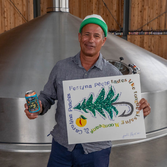 Festina Peche screen print poster displayed in a brewery setting, with a person holding both the handmade print and a Festina Peche beer can in front of stainless steel tanks.