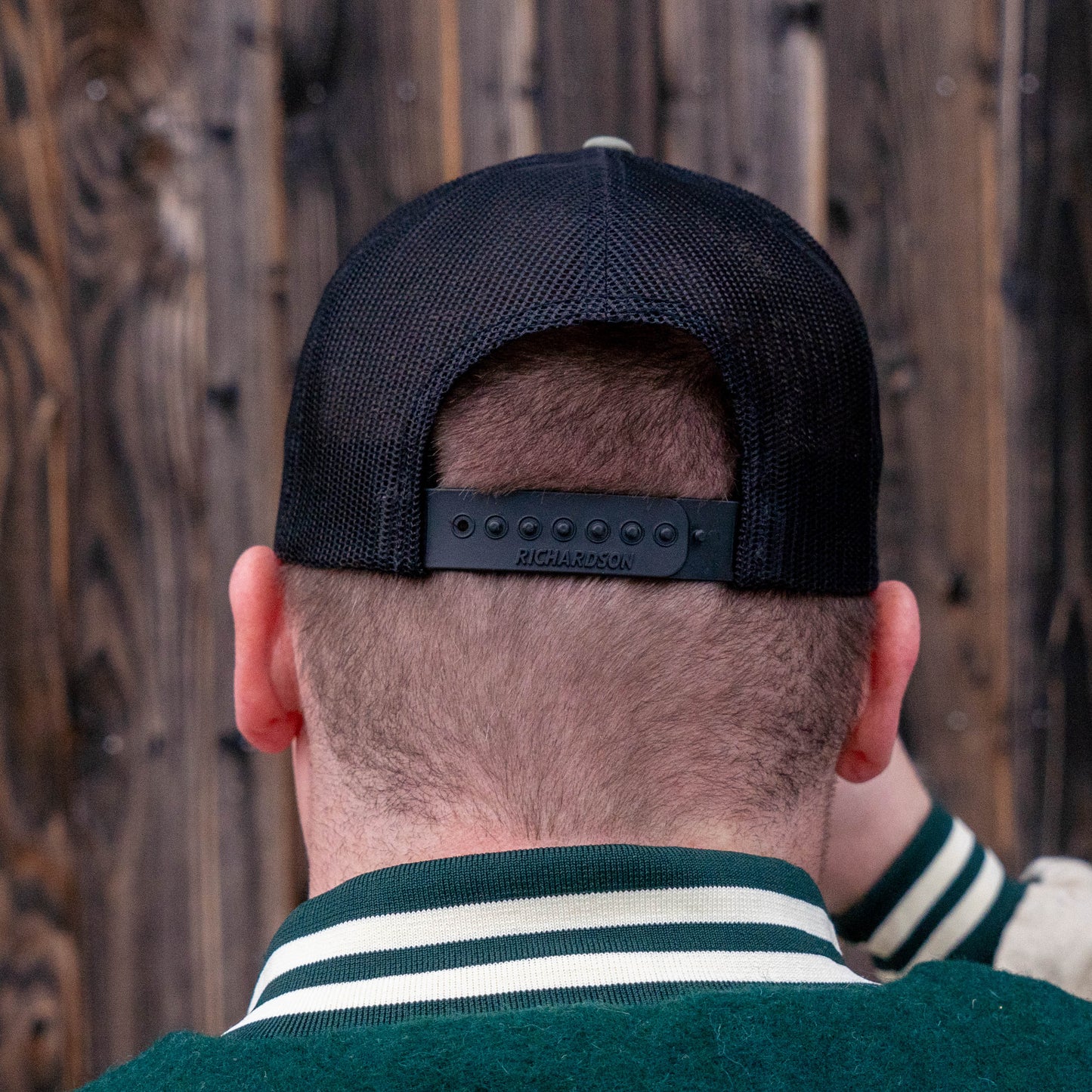 Back side view of the Black and olive patch trucker hat from Dogfish Head