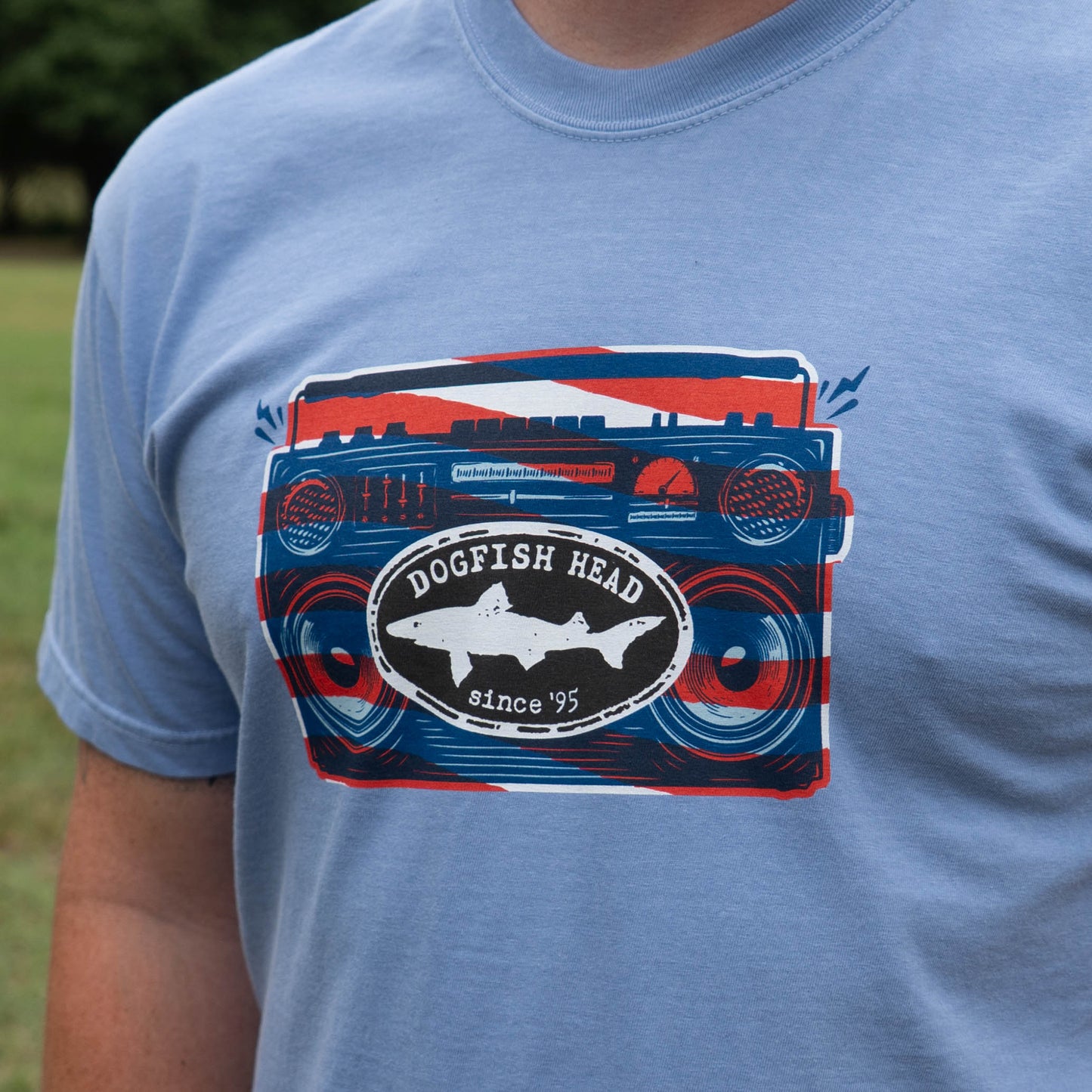 Blue t-shirt with a graphic design featuring 'Dogfish Head' on a grassy background