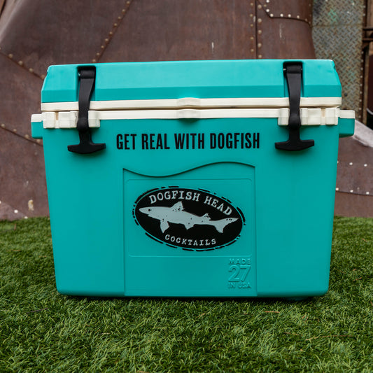 Teal cooler with Dogfish Head Cocktails branding on grass