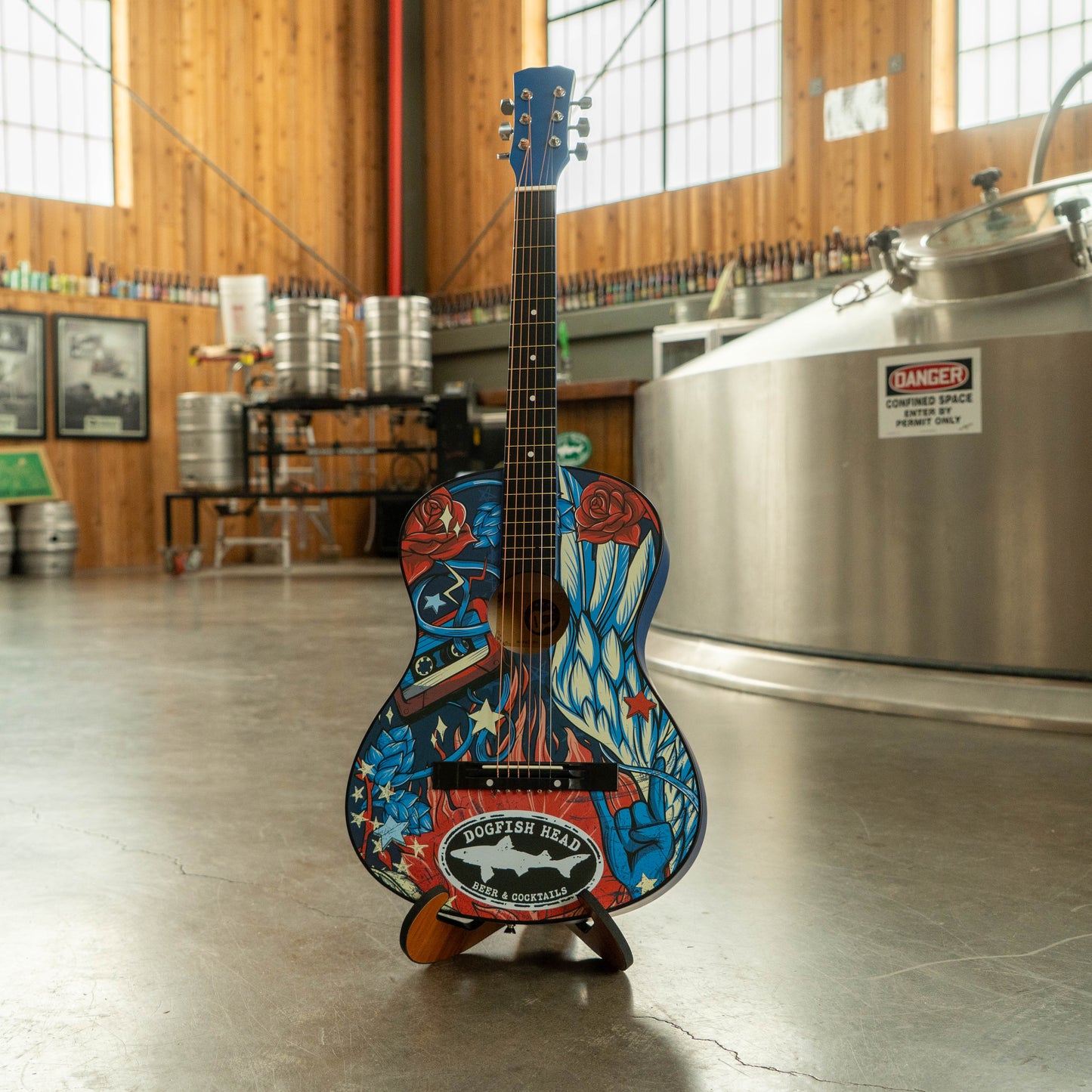 Colorful guitar on a stand in a brewery setting