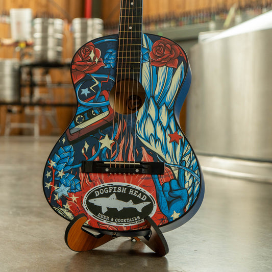 Decorative guitar with colorful design and 'Dogfish Head' logo on a stand.