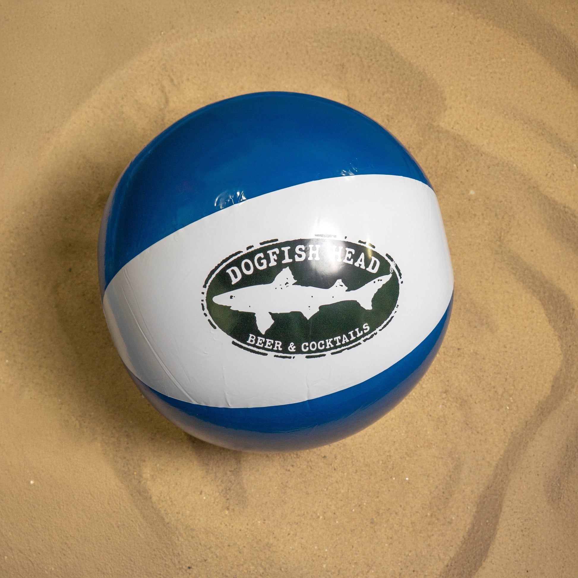 A blue and white beach ball featuring the Merchtank logo is part of this year’s Drink Summer Louder Festival Kit—an essential for summer festivals.