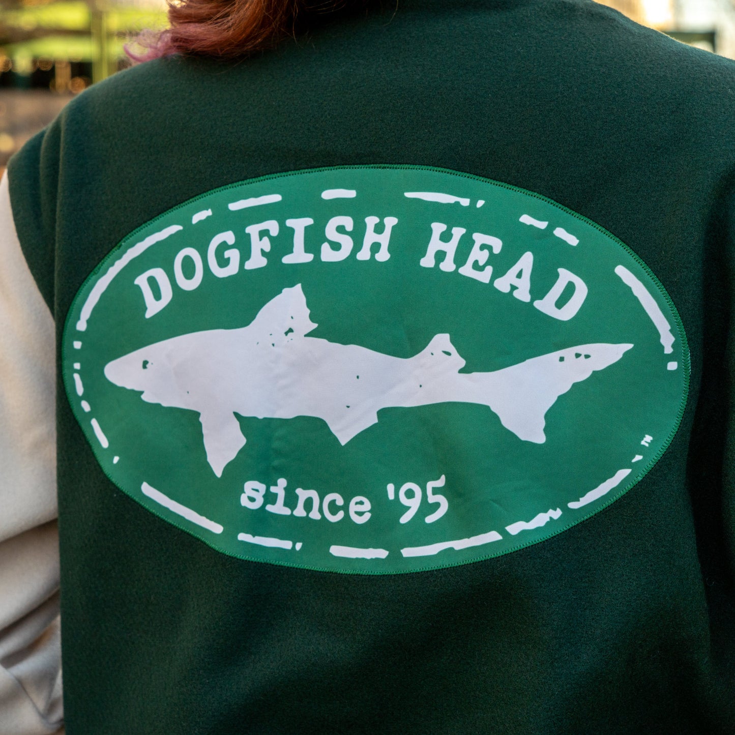 Green varsity jacket with 'Dogfish Head' logo featuring a shark on the back.