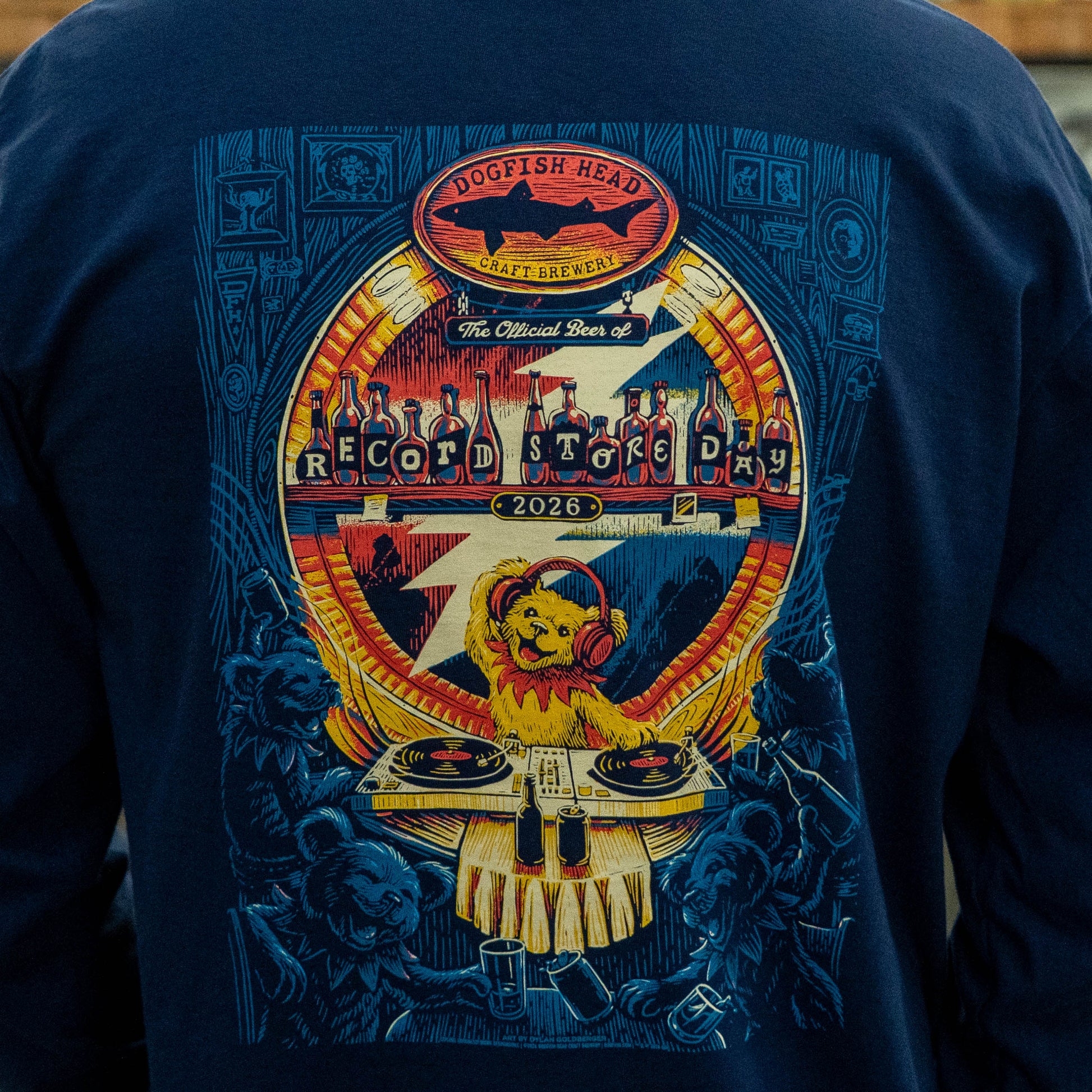 Close-up of back graphic on Dogfish Head x Grateful Dead RSD navy long sleeve tee featuring bear DJ, record turntables, Record Store Day bottle artwork, and bears in a bar scenery.