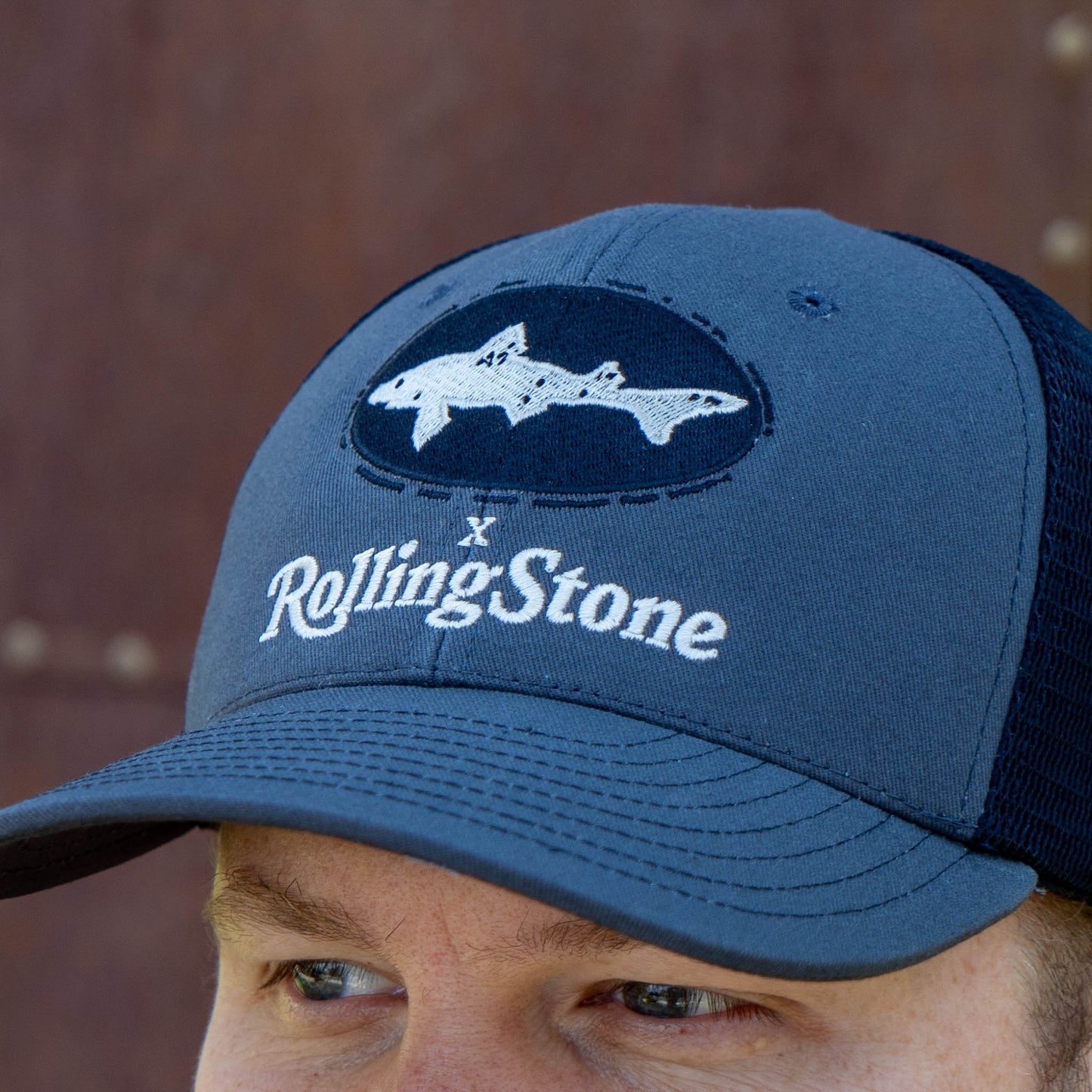 Blue trucker  cap with a darker blue Dogfish Head x Rolling Stone logo