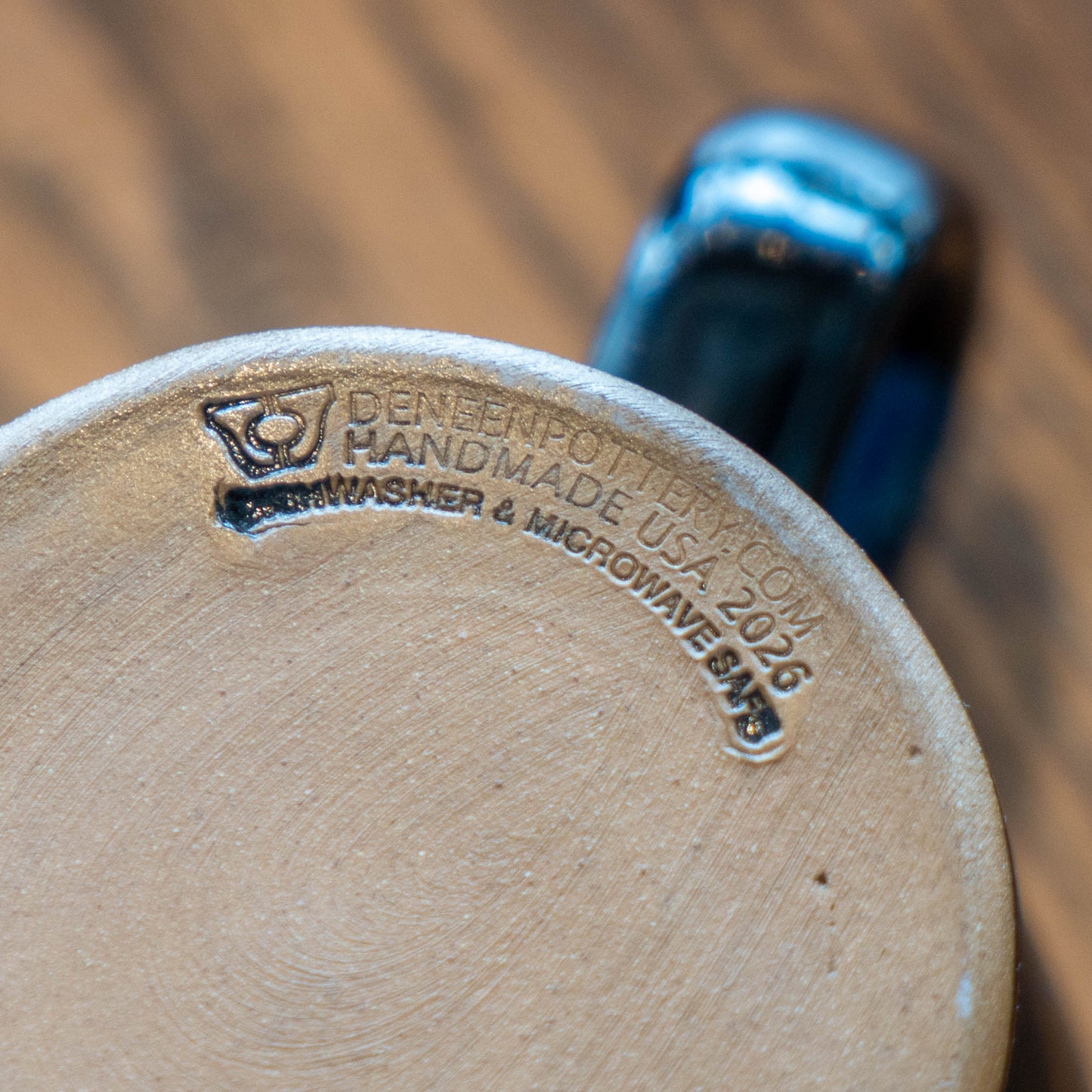 Engraved logo on the outside base of the ceramic mug, labeled "DeneenPottery.Com Handmade USA 2026, Dishwasher and Microwave Safe"