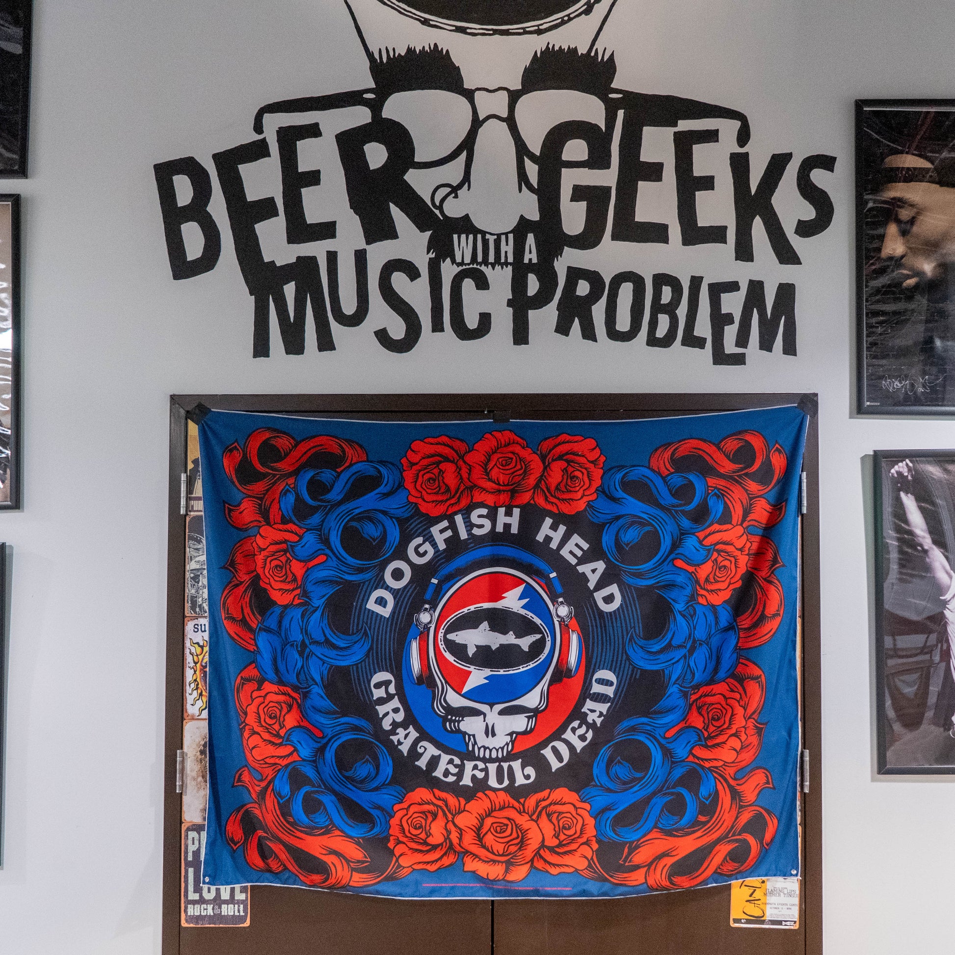 Decorative banner with 'Dogfish Head' and 'Grateful Dead' logos on a door, with text above it.