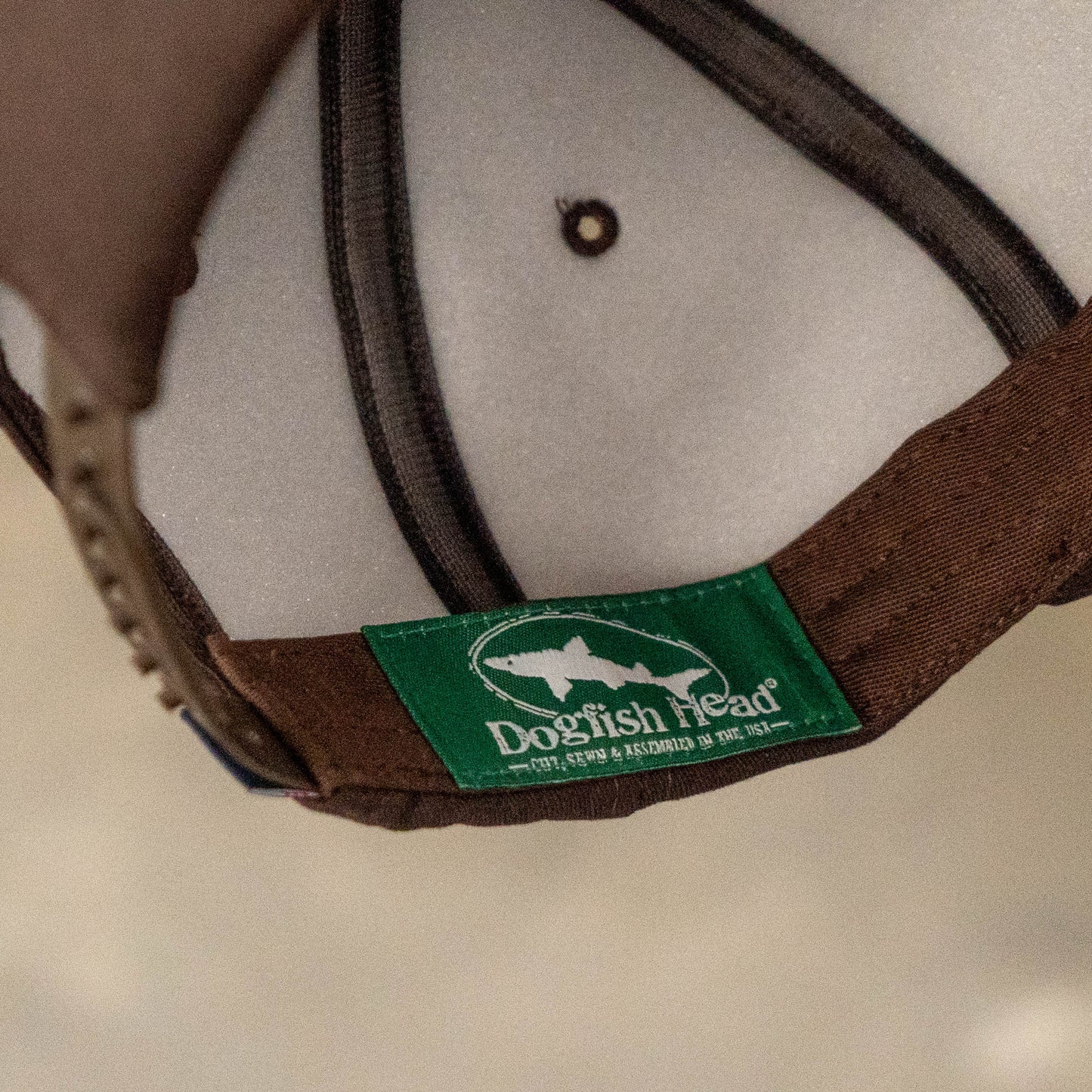 Interior of Dogfish Head x Grateful Dead espresso foam hat showing branded Dogfish Head tag and breathable mesh lining.