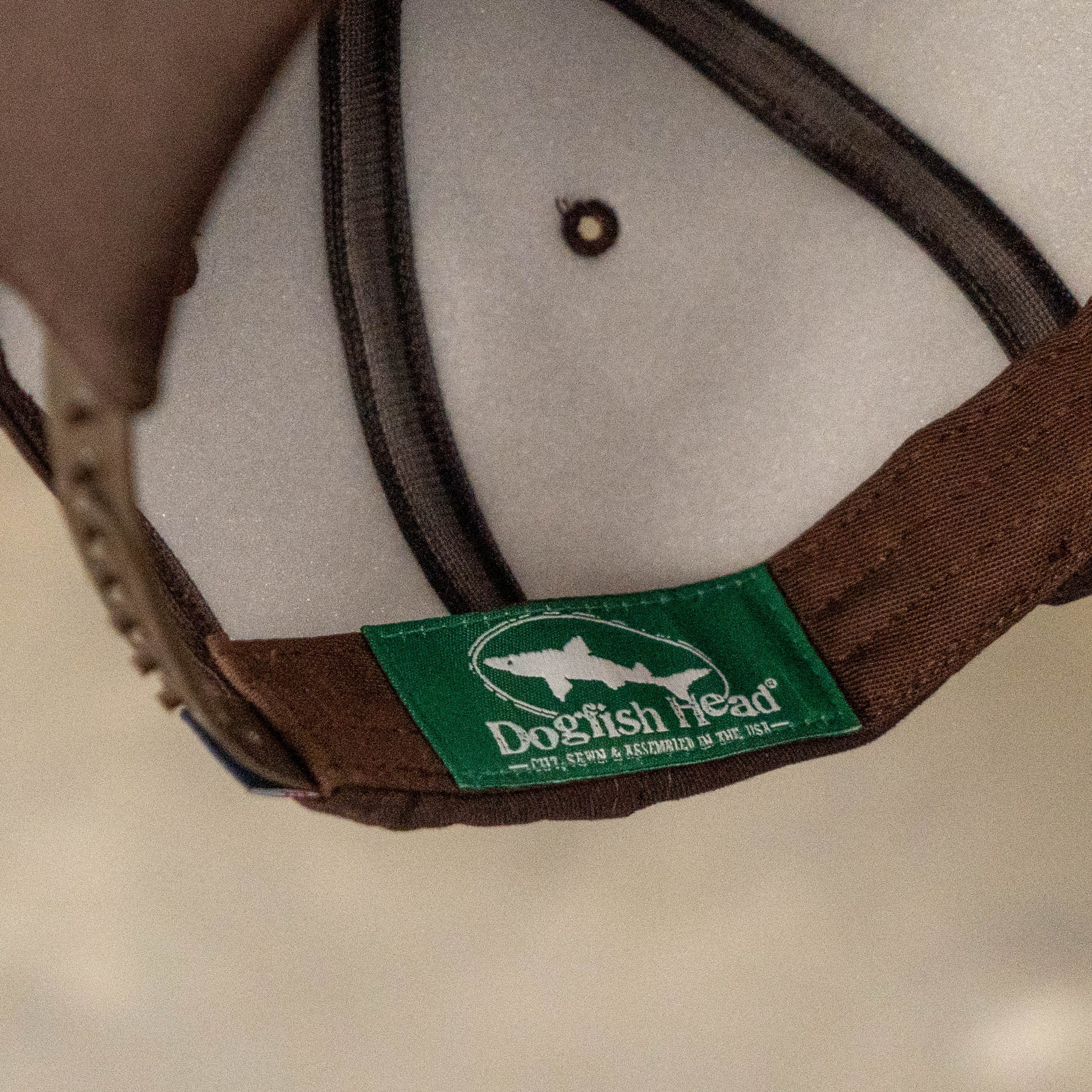 Interior of Dogfish Head x Grateful Dead espresso foam hat showing branded Dogfish Head tag and breathable mesh lining.