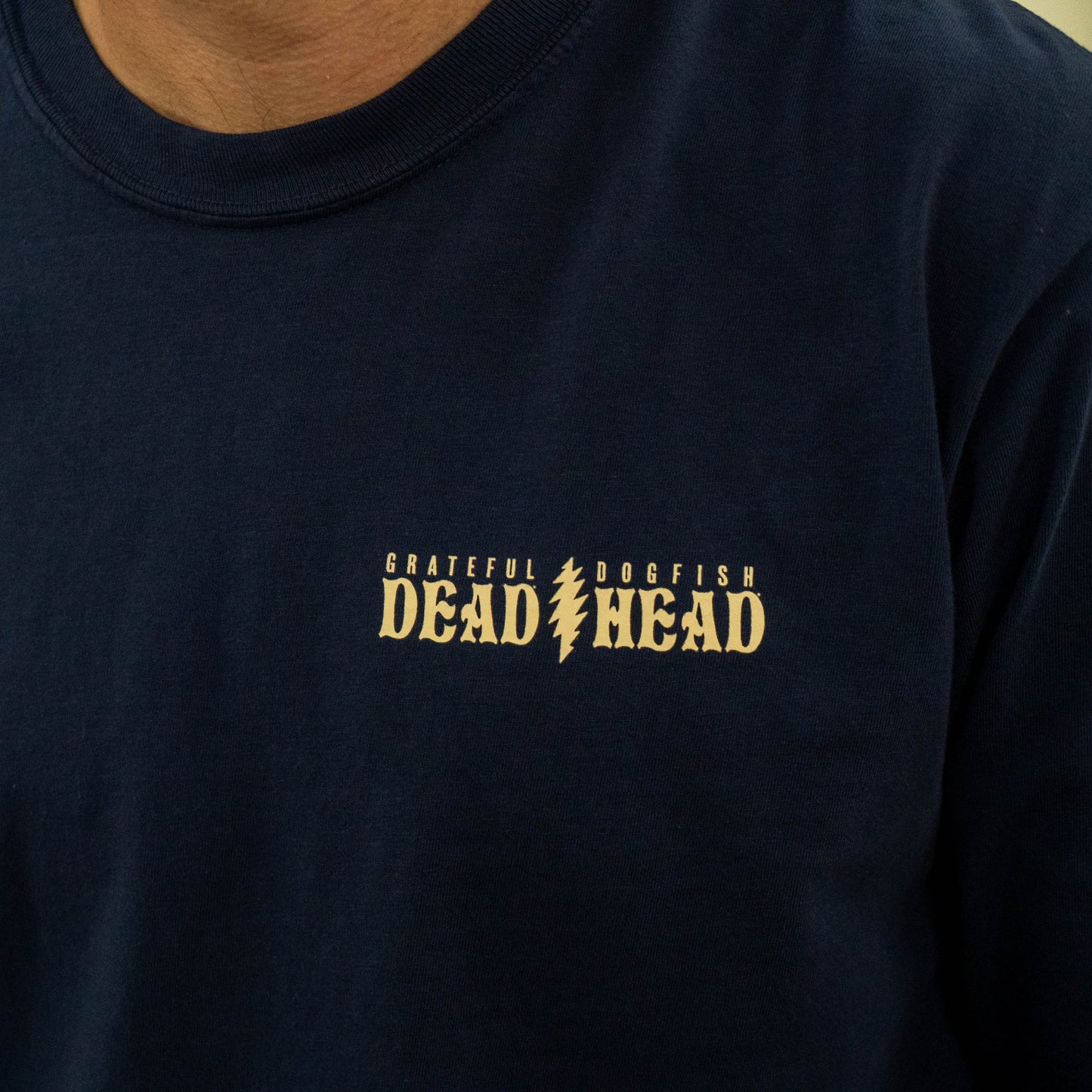 Front chest detail of Dogfish Head x Grateful Dead Record Store Day navy long sleeve shirt with small collaborative logo reading "Grateful Dead, Dogfish Head."