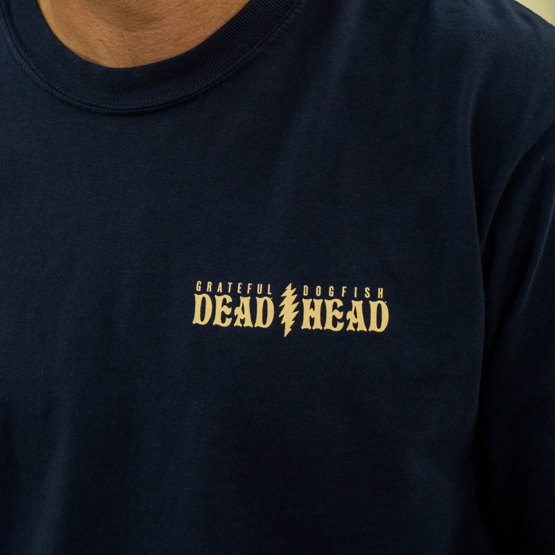 Front chest detail of Dogfish Head x Grateful Dead Record Store Day navy long sleeve shirt with small collaborative logo reading "Grateful Dead, Dogfish Head."