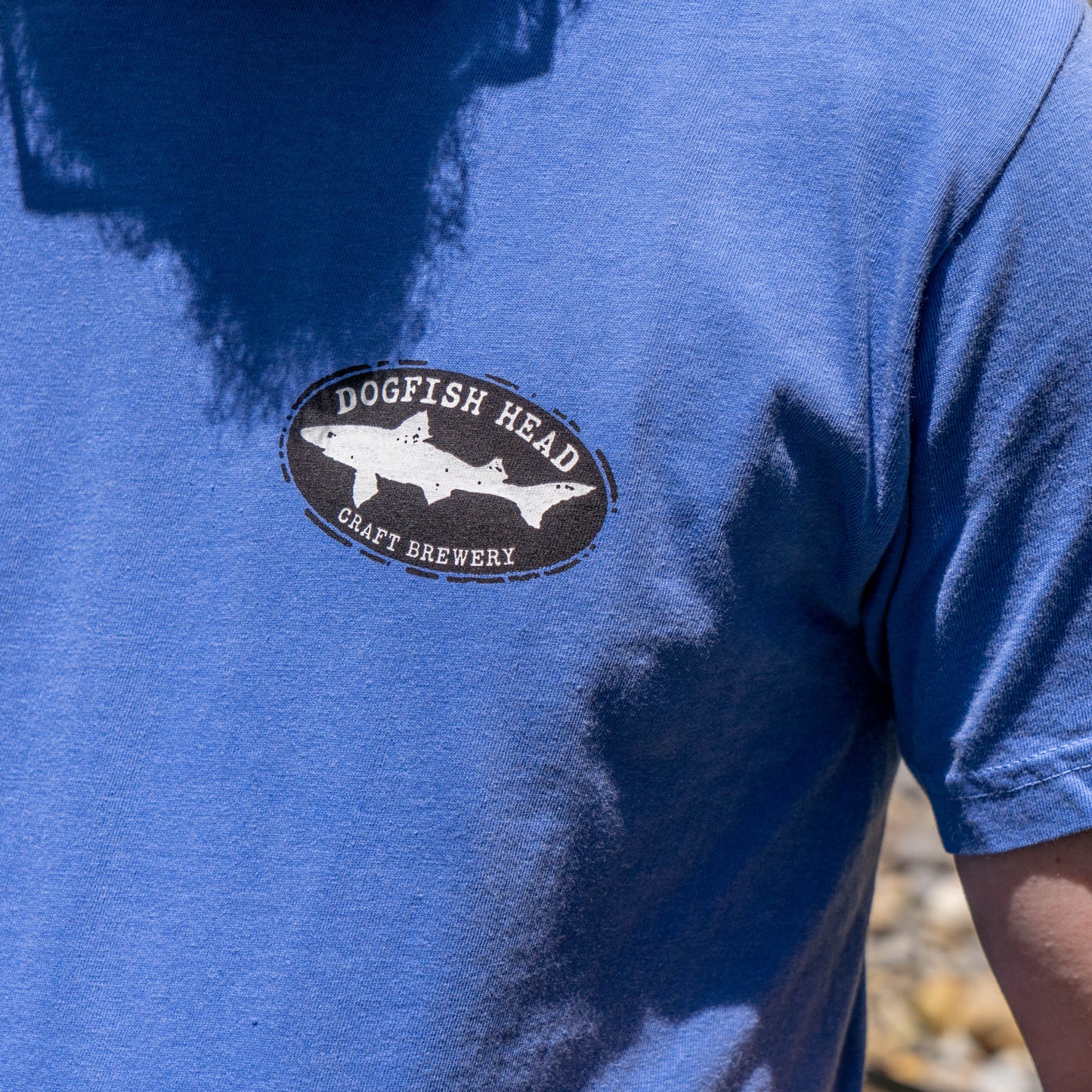 A person wears the GO WEST T-SHIRT COMPANY FLO Blue Treehouse Short Sleeve Tee Shirt—ideal casual wear for those who appreciate unique style and comfort.
