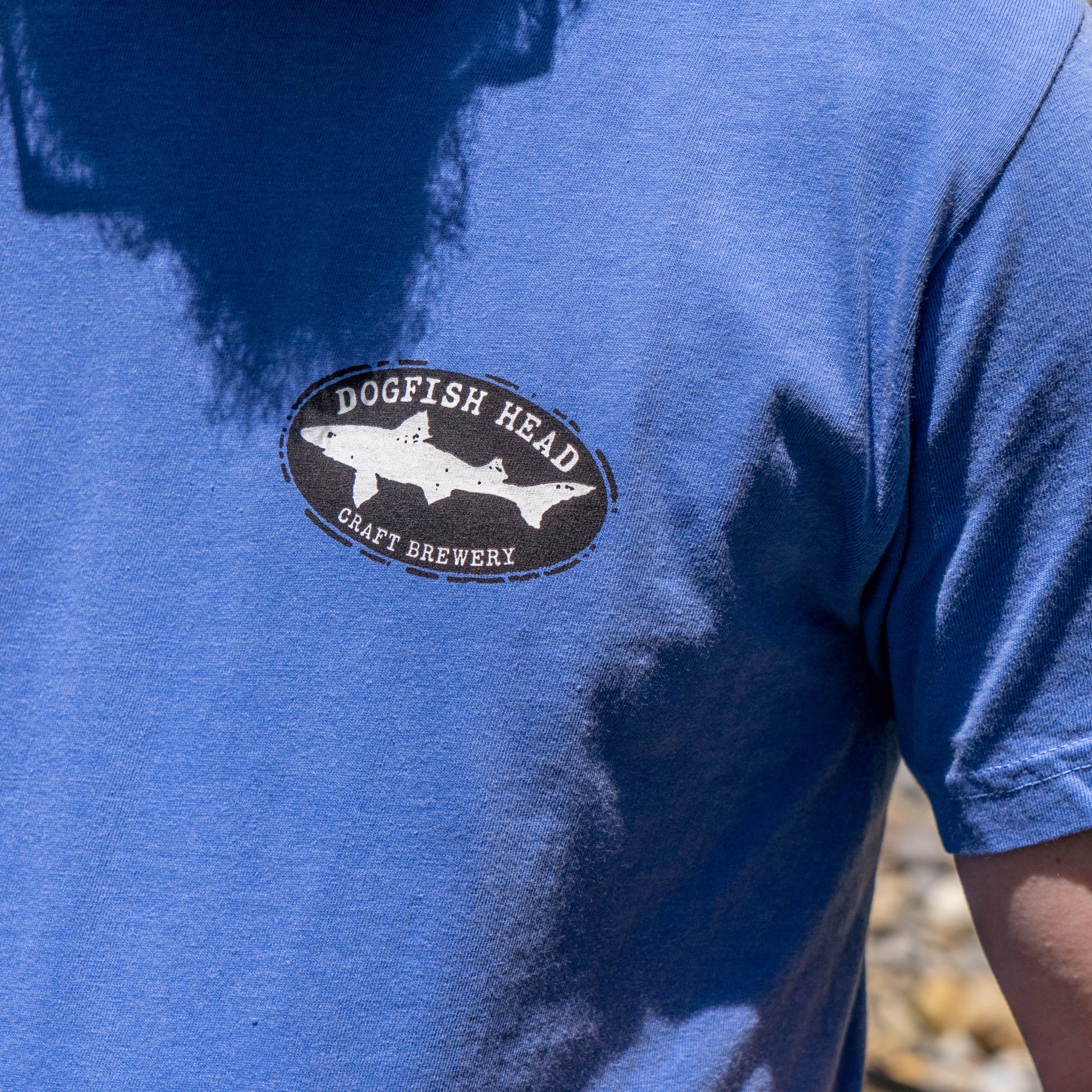 A person wears the GO WEST T-SHIRT COMPANY FLO Blue Treehouse Short Sleeve Tee Shirt—ideal casual wear for those who appreciate unique style and comfort.