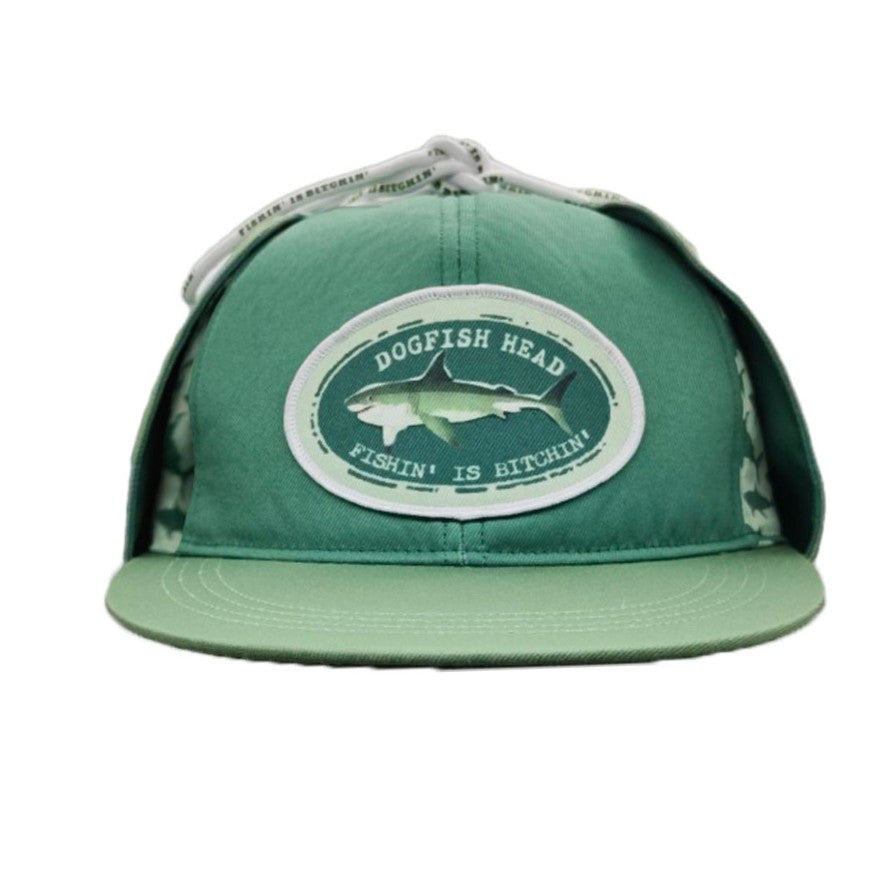 A green snapback cap featuring a circular 'Dogfish Head' patch on the front with a shark graphic and the text 'FISHING IS BITCHIN''.