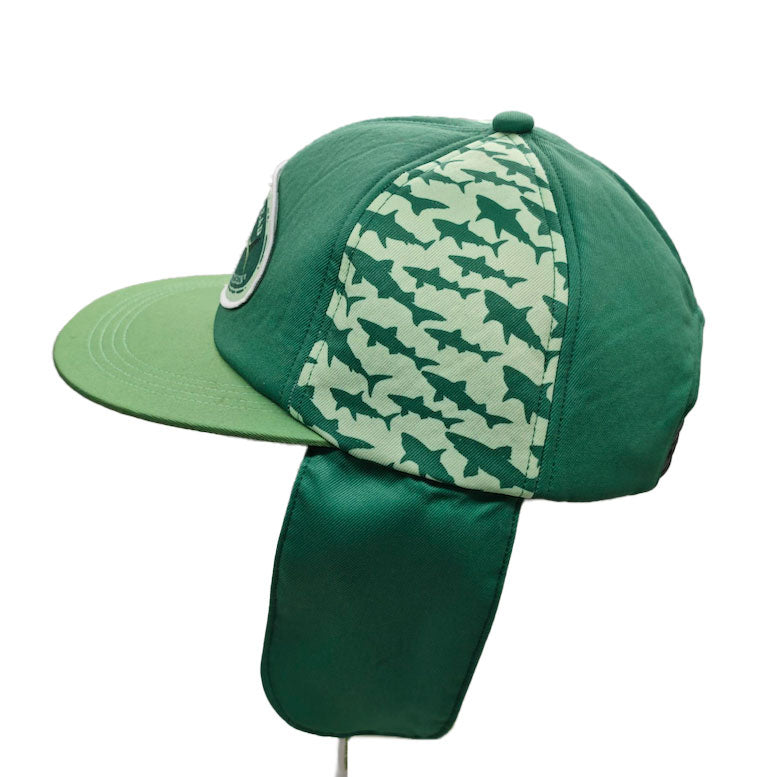 The Fishin' is Bitchin' Retro Hat with Ear Flaps from Grandstand Glassware & Apparel is a limited edition green fishing hat featuring a neck flap and a panel decorated with dark green shark silhouettes on a light green background—an ideal pick for Dogfish Head fans.