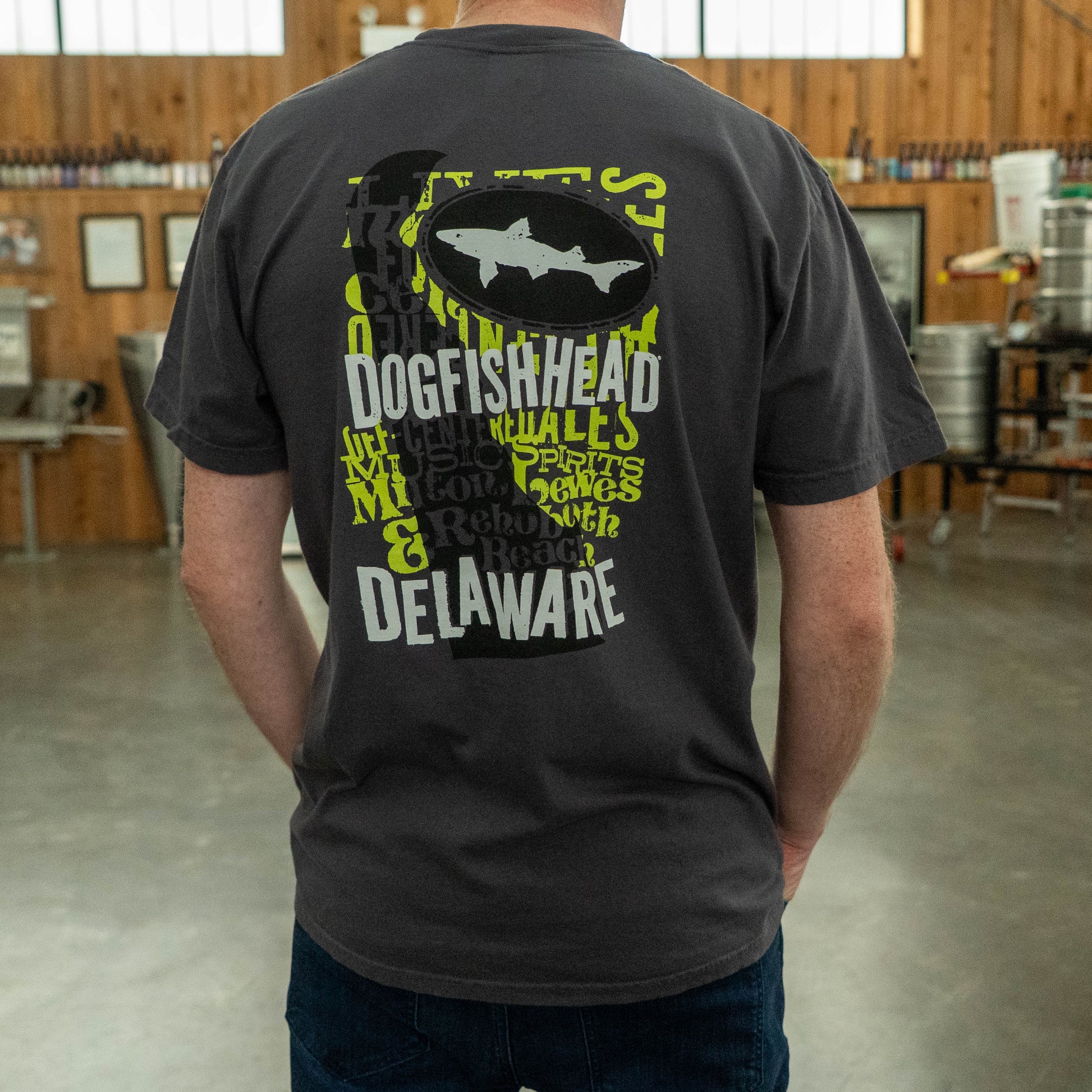 Back view of the graphite Dogfish Head Delaware T‑shirt featuring a large shark graphic and stylized “Dogfish Head Delaware” text.