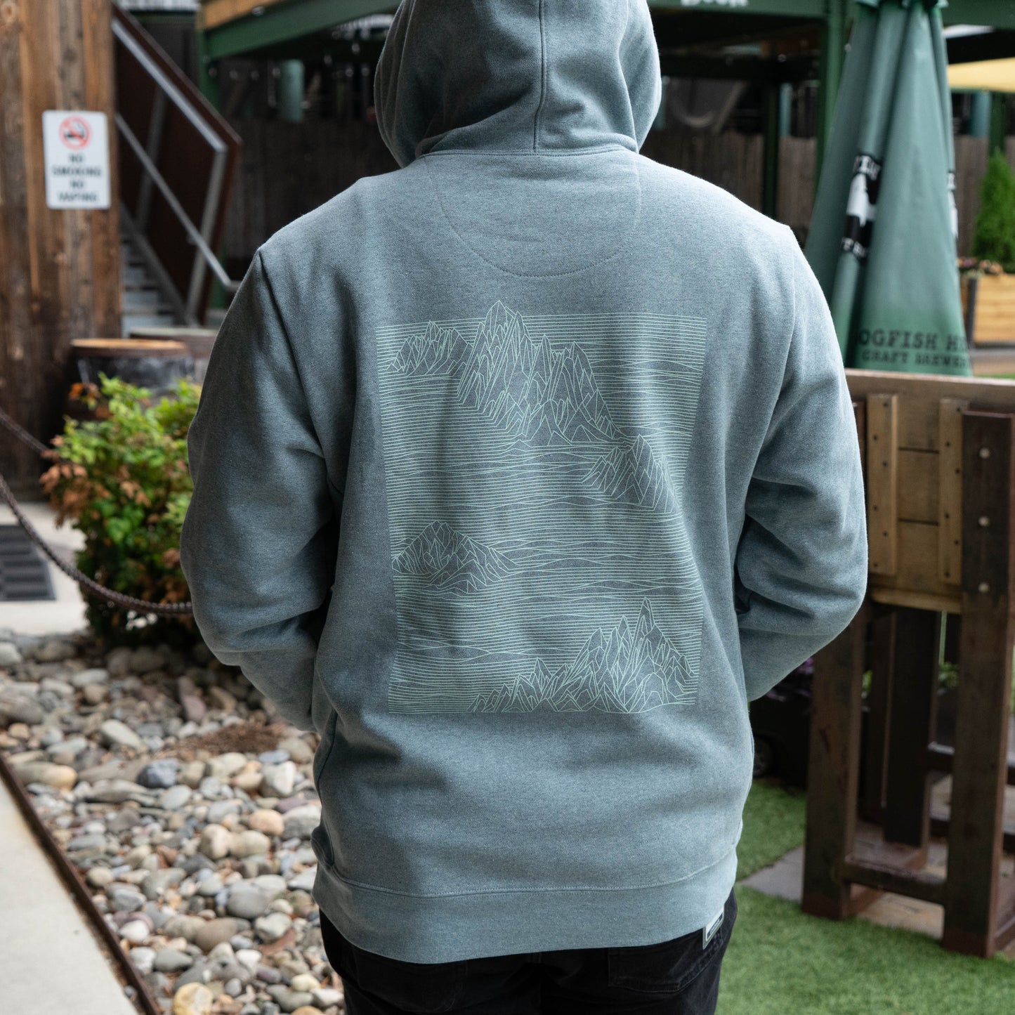 Patagonia grey Strataspire Uprisal hoody back view showcasing mountain line art graphic, made with recycled materials for everyday comfort and outdoor style