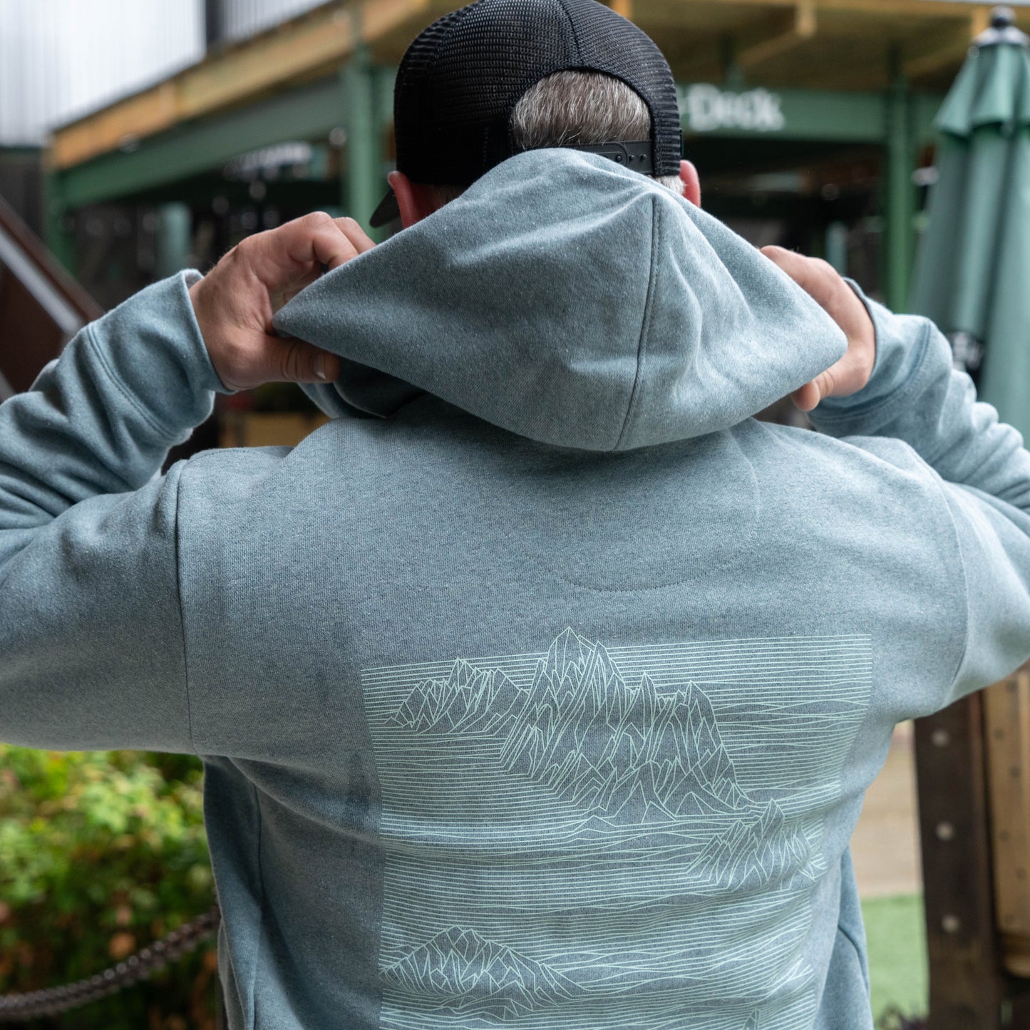 Close-up of Patagonia Strataspire Uprisal hoody hood and neckline in grey fleece, highlighting durable fabric, adjustable hood, and casual fit