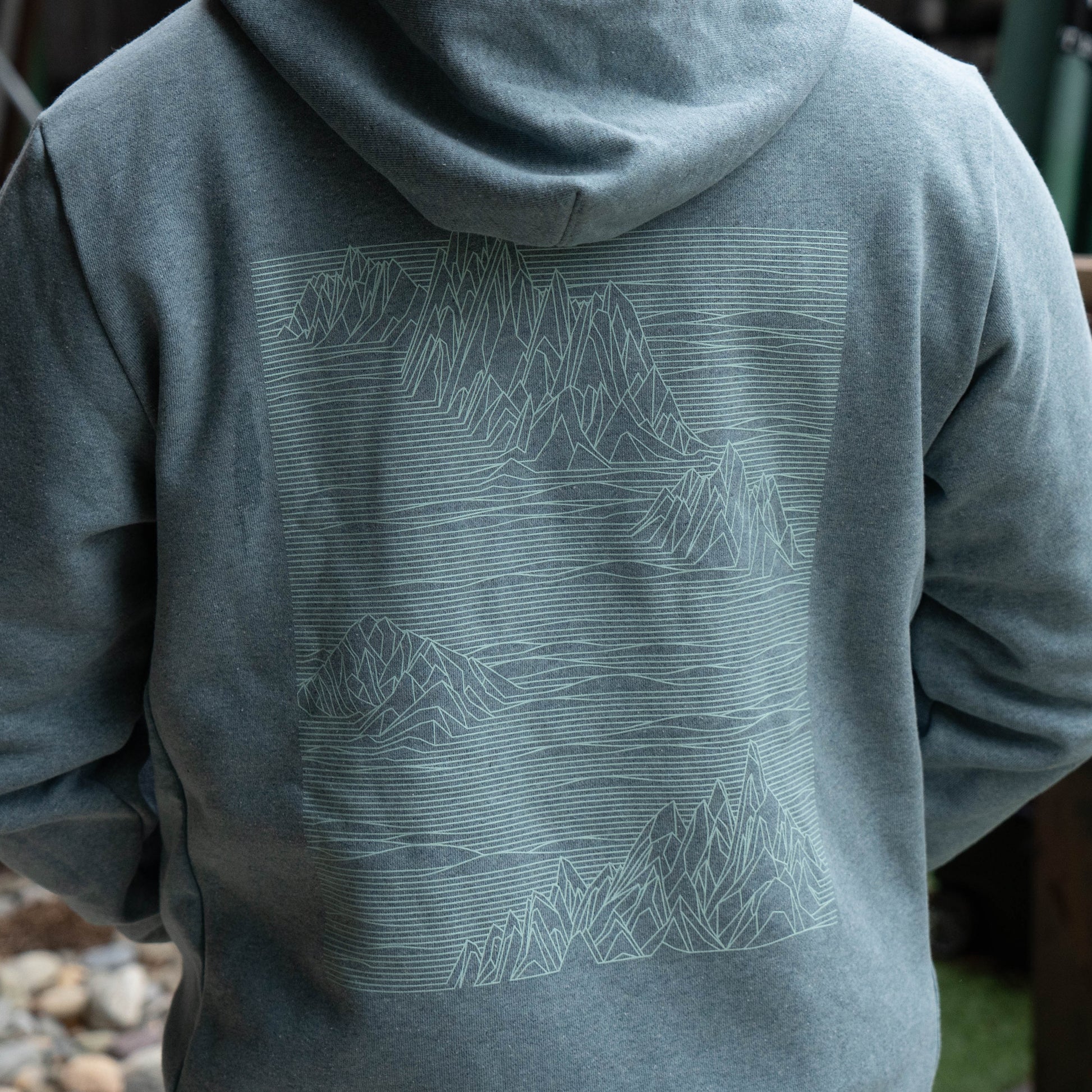Close-up of grey Patagonia Strataspire Uprisal hoody featuring minimalist line-art mountain graphic, soft fleece fabric, outdoor apparel detail