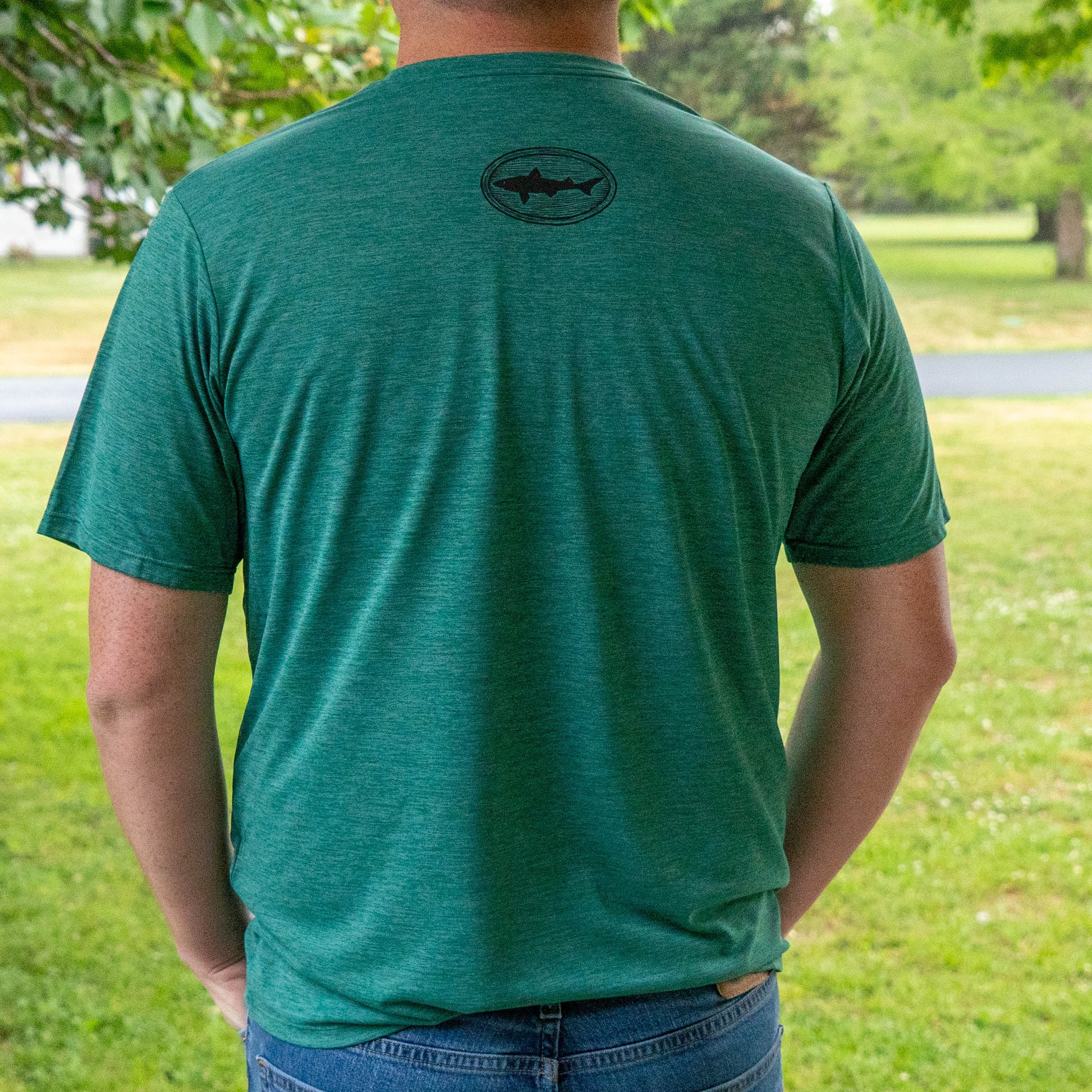 Patagonia green Cap Cool Daily t-shirt back detail with Dogfish Head shark emblem, moisture-wicking athletic shirt in outdoor setting