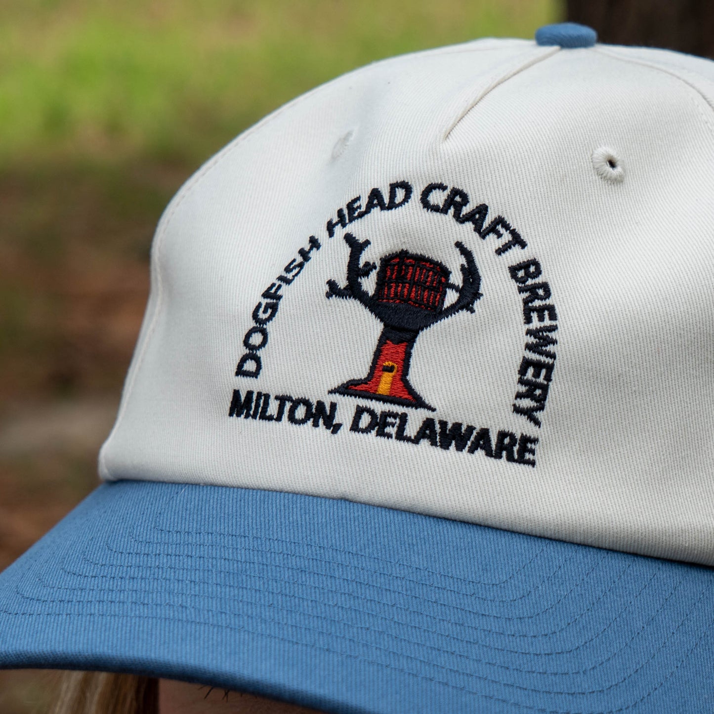 White and blue cap with Dogfish Head Craft Brewery logo and text.