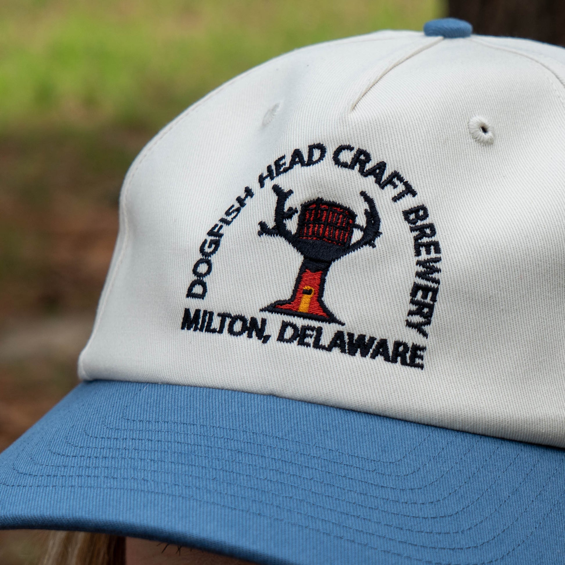White and blue cap with Dogfish Head Craft Brewery logo and text.