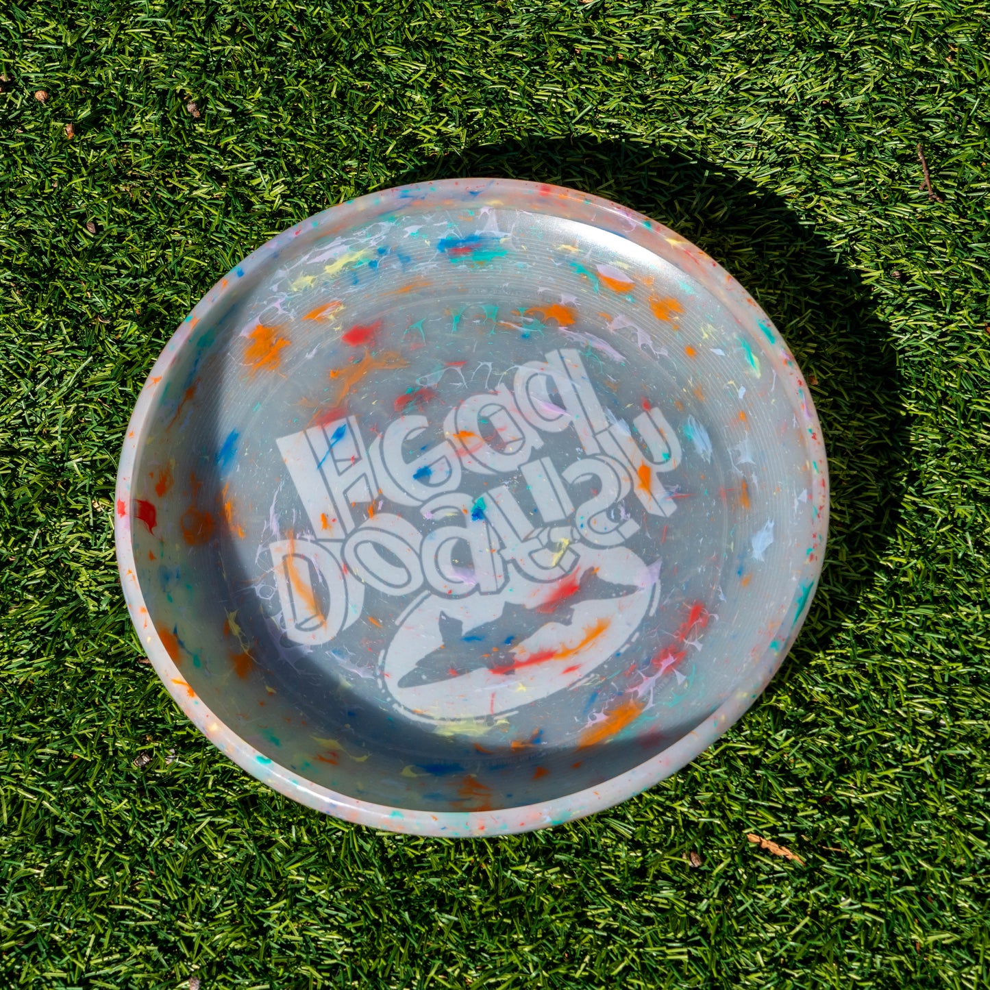 Backside of grey dogfish head frisbee with tie dye accents.