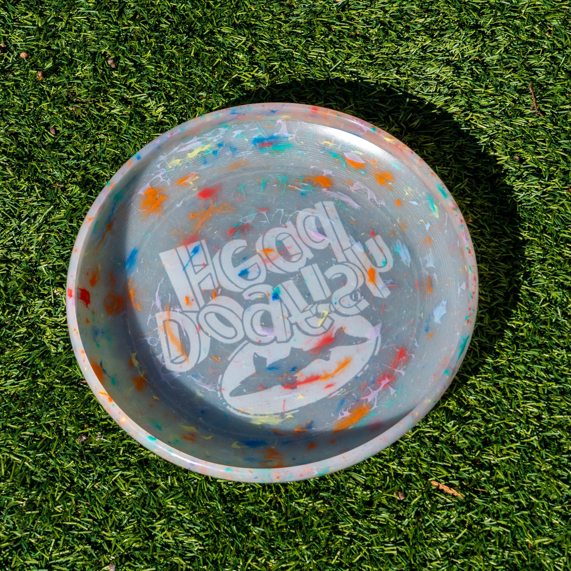 Backside of grey dogfish head frisbee with tie dye accents.