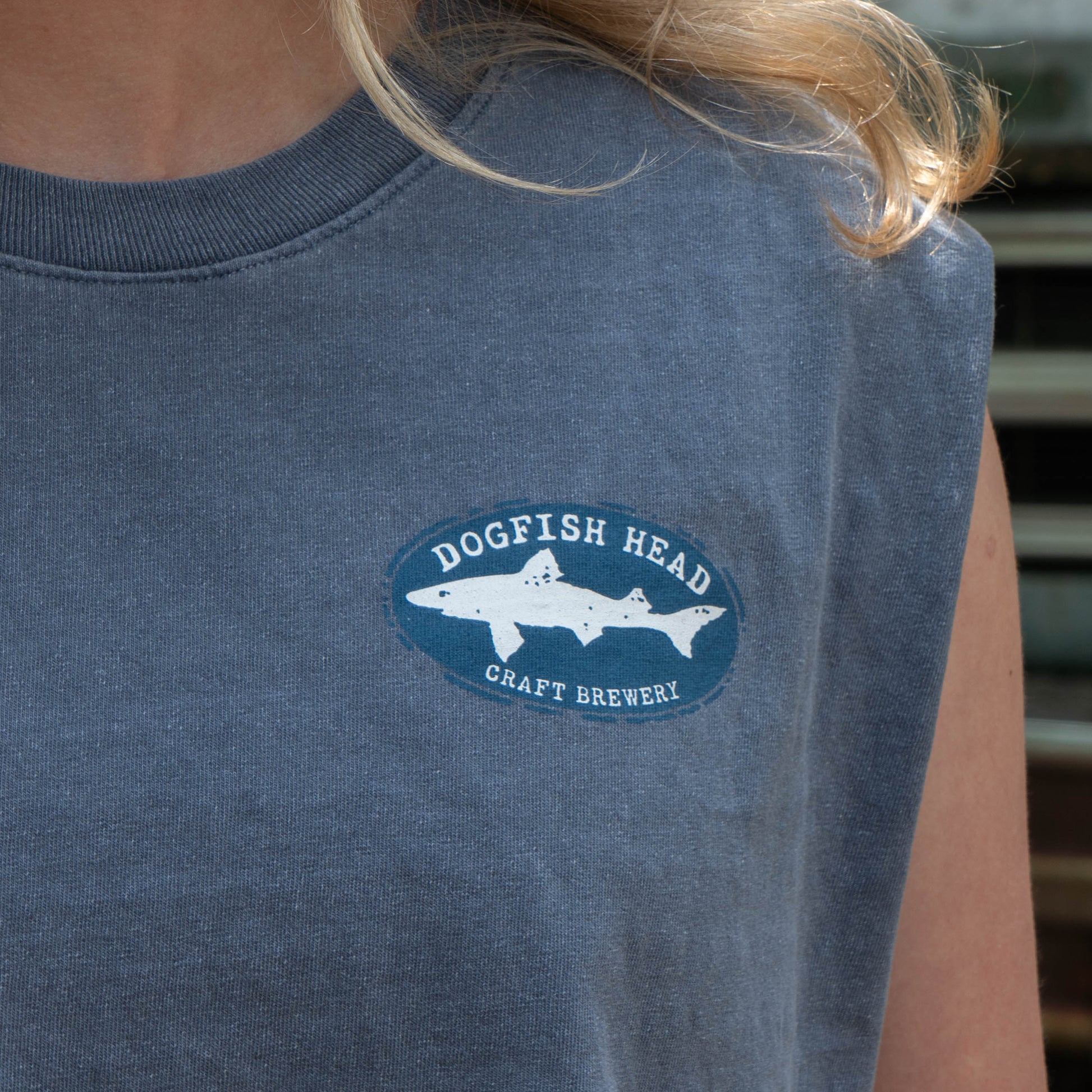 Person wearing a blue t-shirt with Dogfish Head Craft Brewery logo