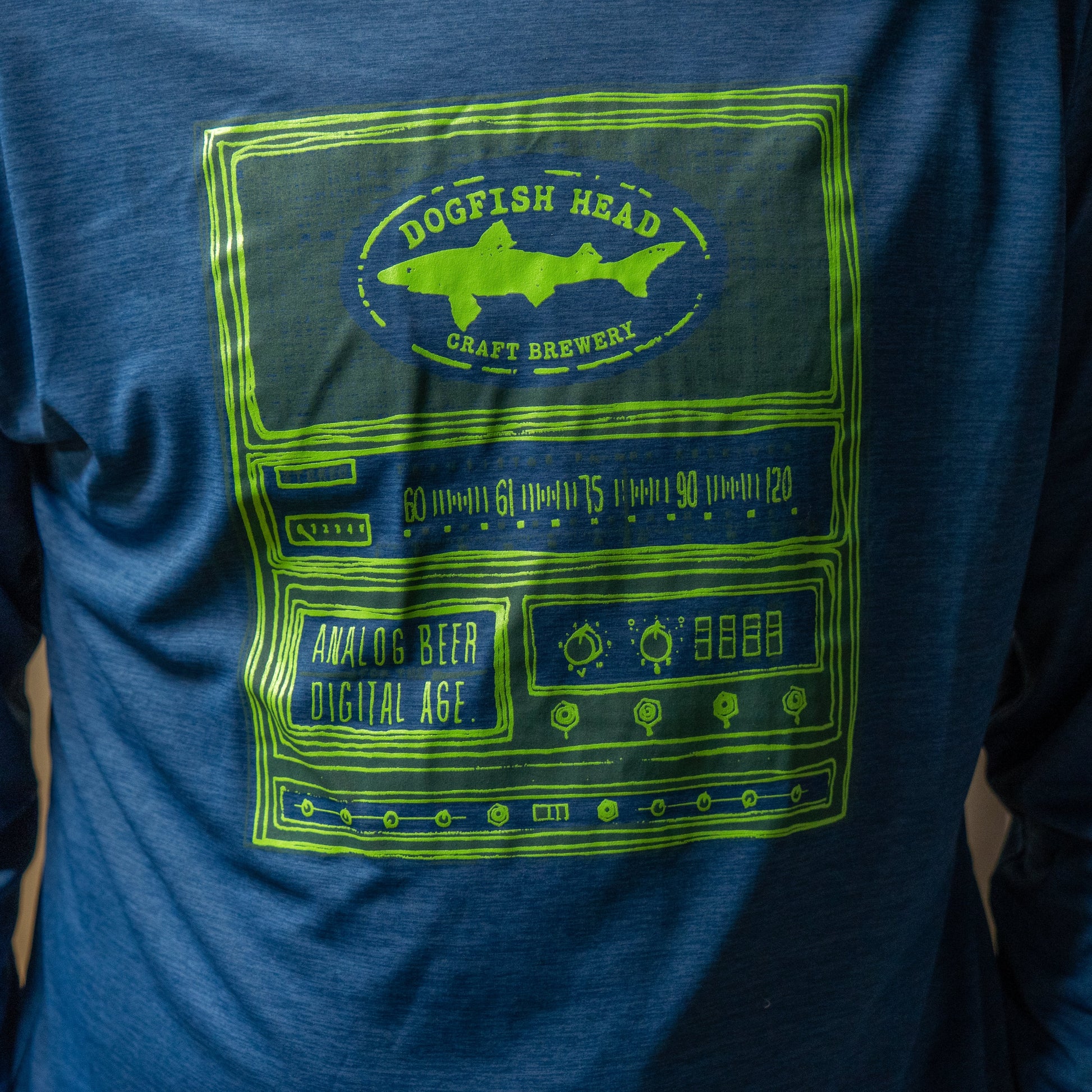 The Patagonia M Blue Long Sleeve Runner features a green Dogfish Head Craft Brewery graphic above illustrated audio equipment and the text "Analog Beer Digital Age," all made from recycled polyester.