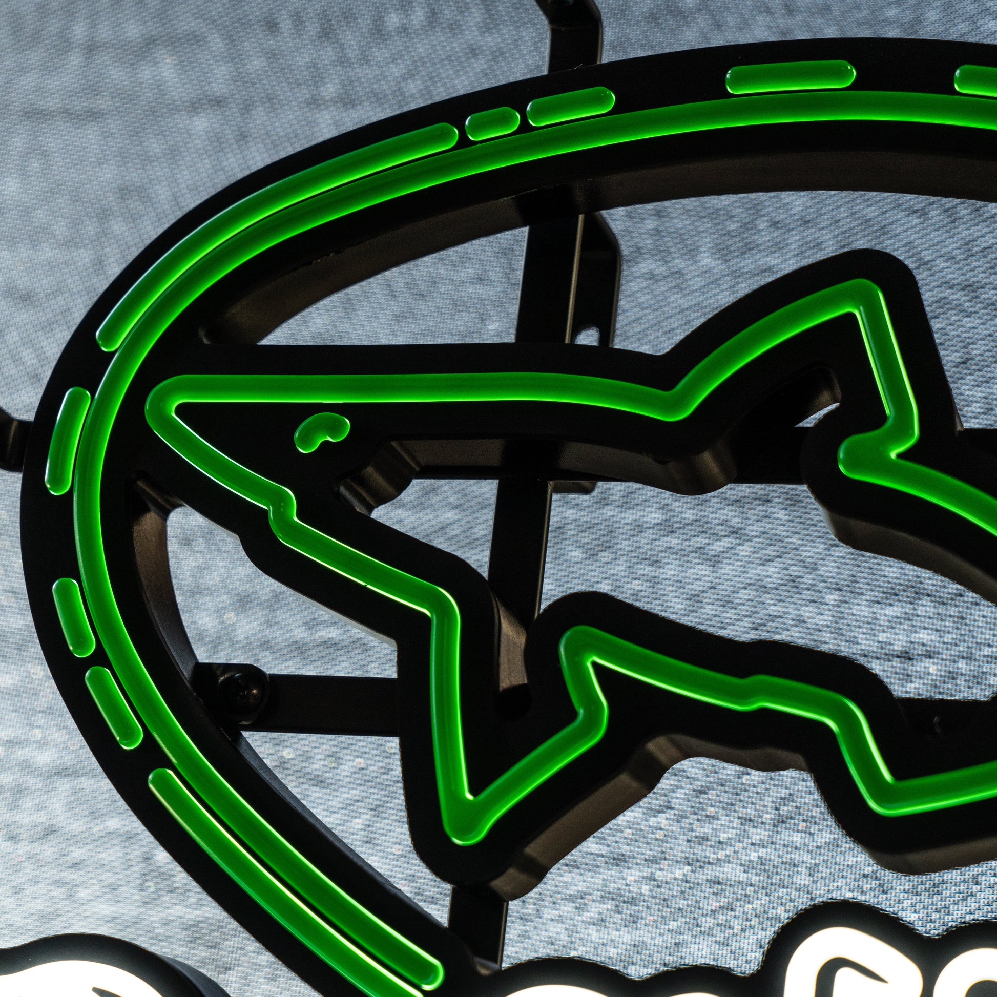 Close‑up of Dogfish Head LED neon light showing glowing green shark logo outline and sleek LED tubing