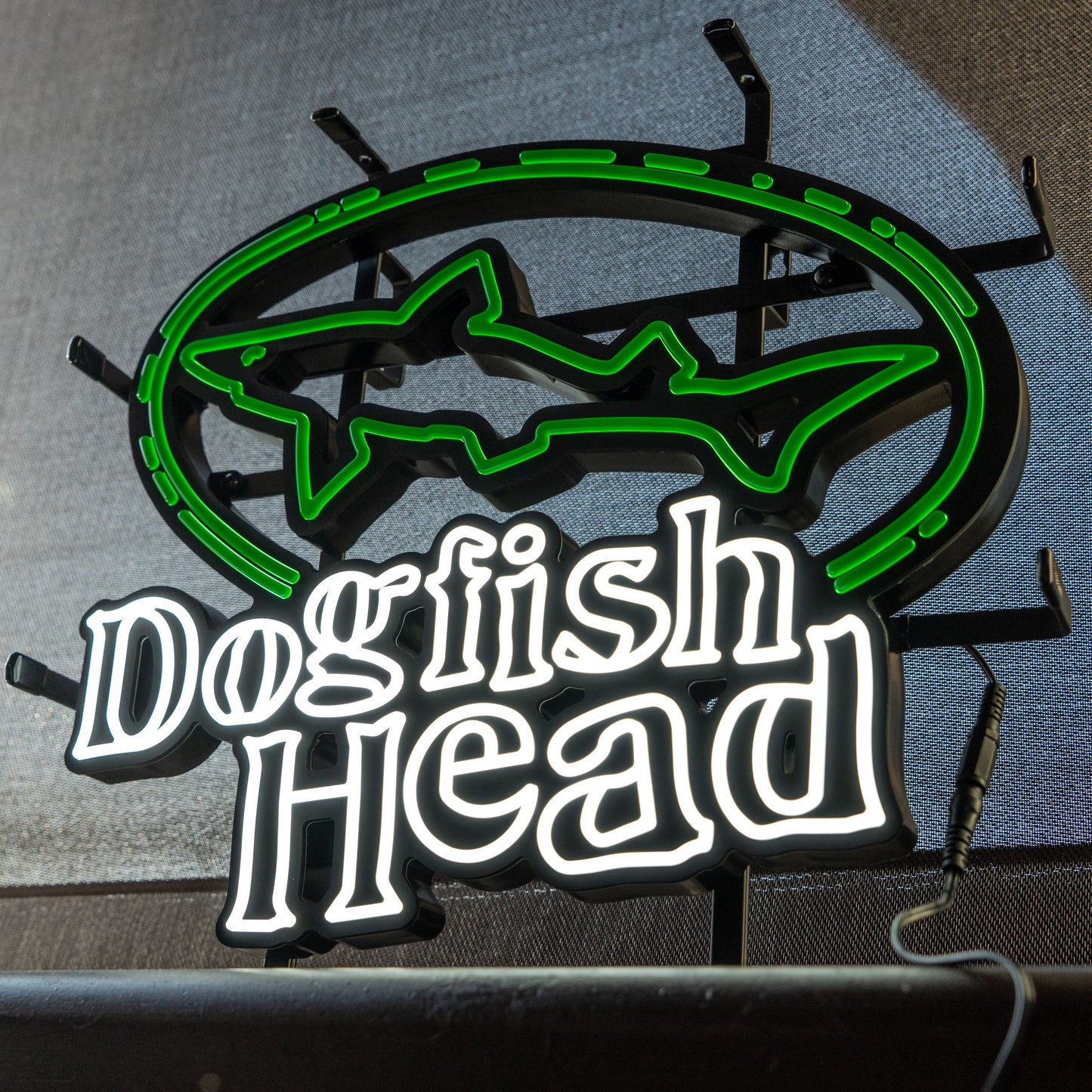 Dogfish Head LED neon sign with green shark logo and white lettering, mounted and powered on for bar or home décor