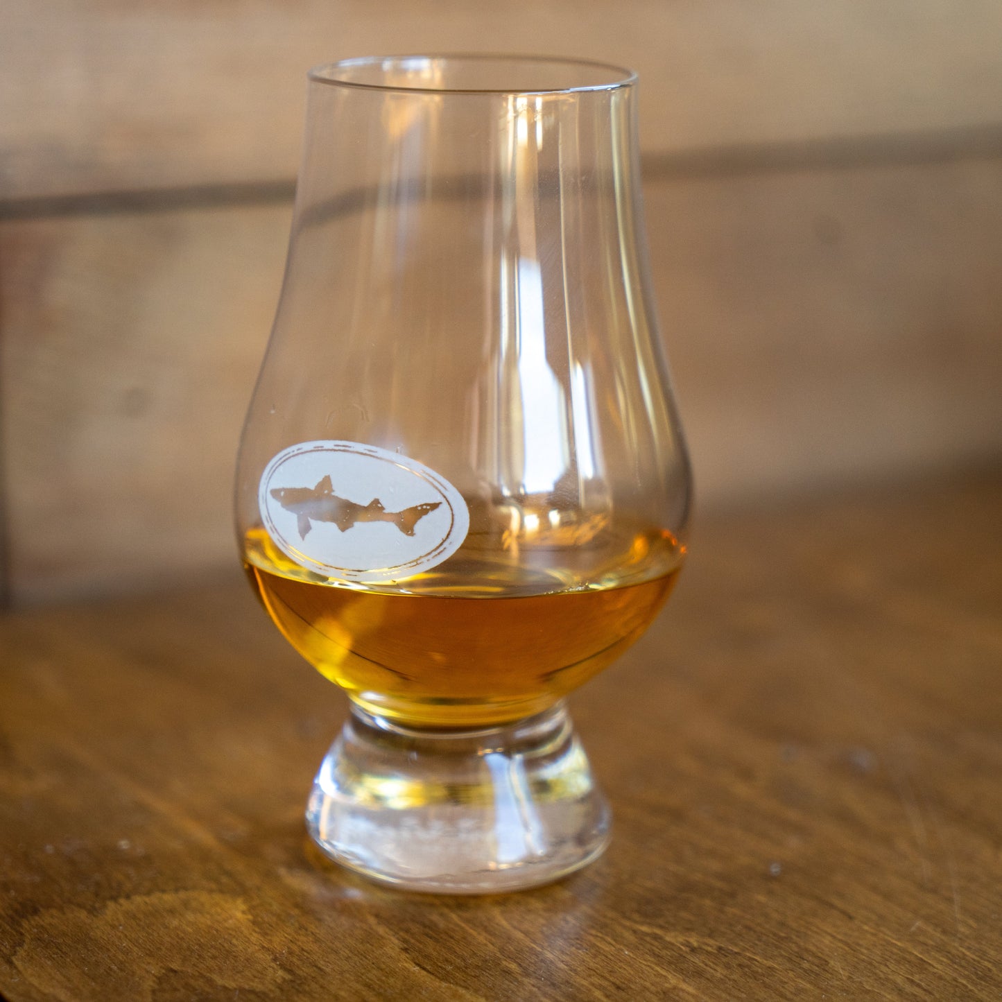 Dogfish Head branded Glencairn tasting glass with white Dogfish shark logo, designed for whiskey and craft spirits