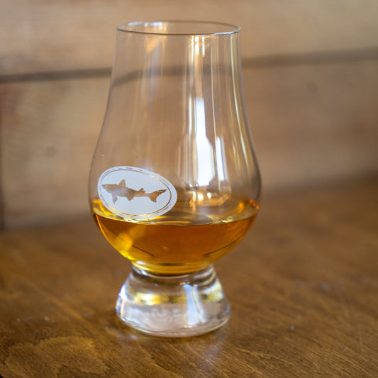 Dogfish Head branded Glencairn tasting glass with white Dogfish shark logo, designed for whiskey and craft spirits