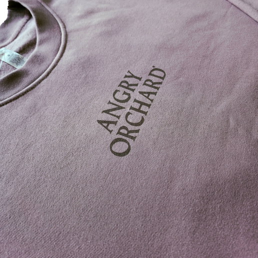 Close-up of the front of crewneck with centered writing of "Angry Orchard".