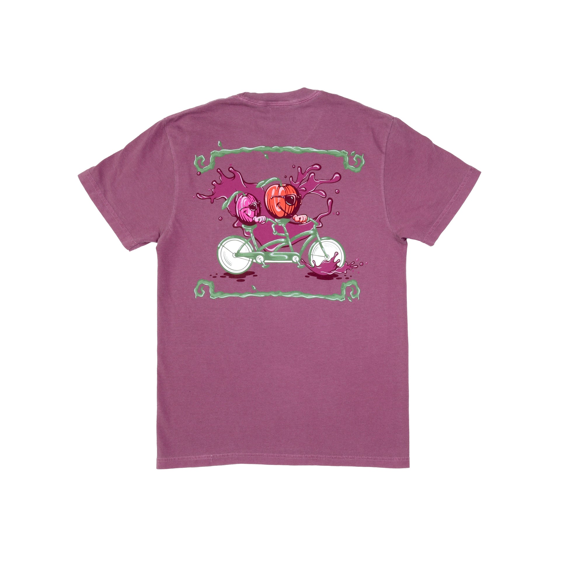 Backside of Plum Bike Short Sleeve Tee. The backside of this shirt shows a purple plum and red apple riding a sage green and white tandem bike. Plum colored splashes sit at the wheels of the bike and background of the imagery with sage green lines that mimic tree branches border the top and bottom edges of the visual. 