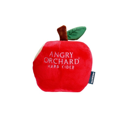Dog toy is Angry Orchard's iconic bitten red apple. "Angry Orchard Hard Cider" is written on the front of the toy.