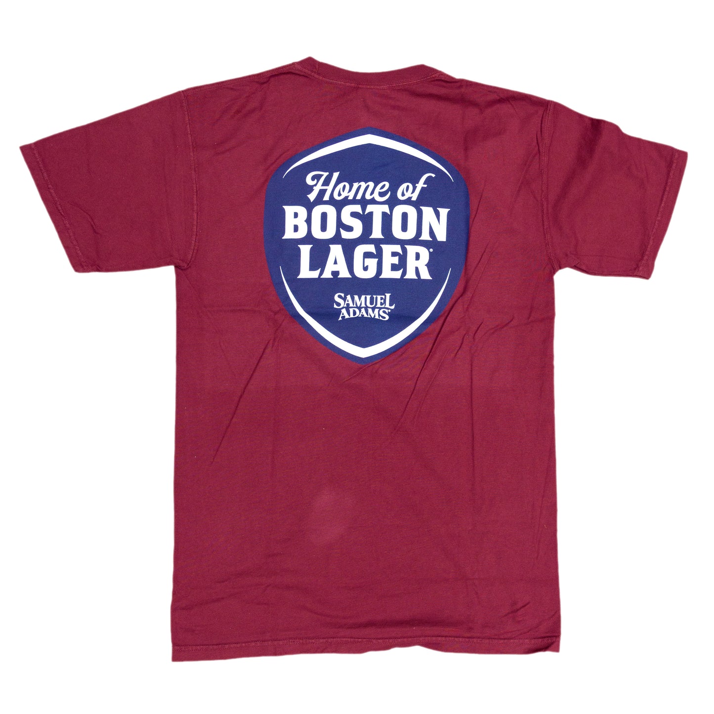 Back view of the red tee features a large blue shield. Sheild features writing "Home of the Boston Lager" and the Samuel Adams logo below.