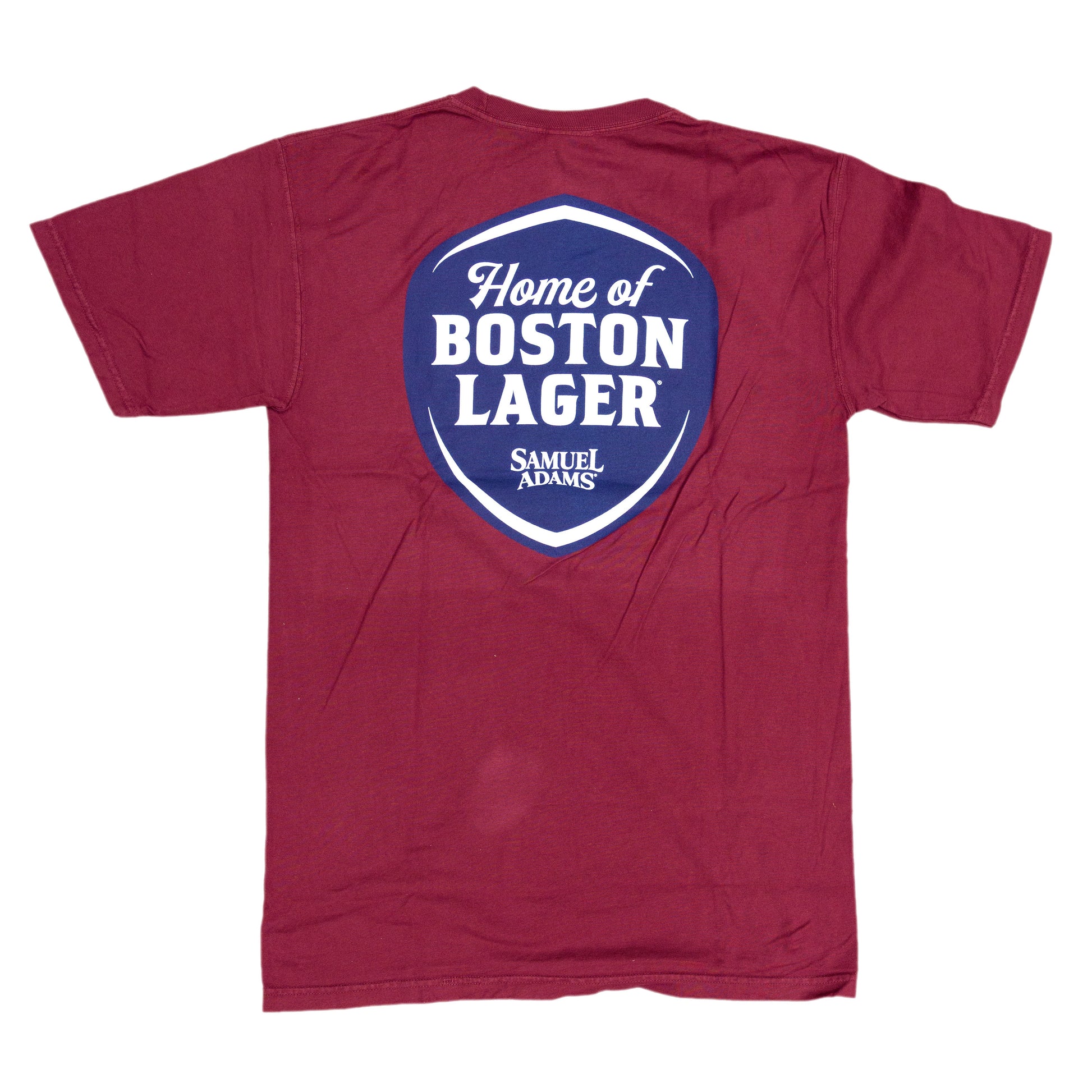 Back view of the red tee features a large blue shield. Sheild features writing "Home of the Boston Lager" and the Samuel Adams logo below.