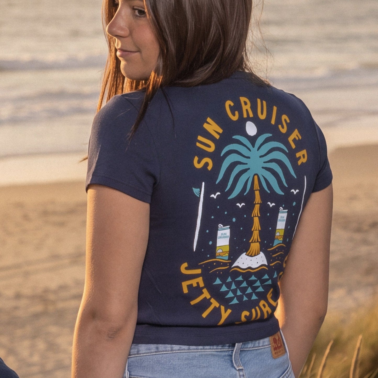 Navy tee shirt on a person on a beach. 