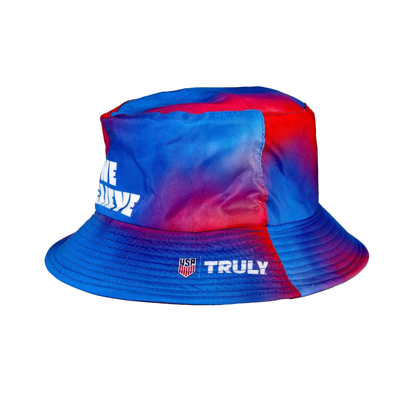 Side view of red and blue tie dye bucket hat with a USA logo and Truly logo in white text on the brim and "We Believe" on the backside
