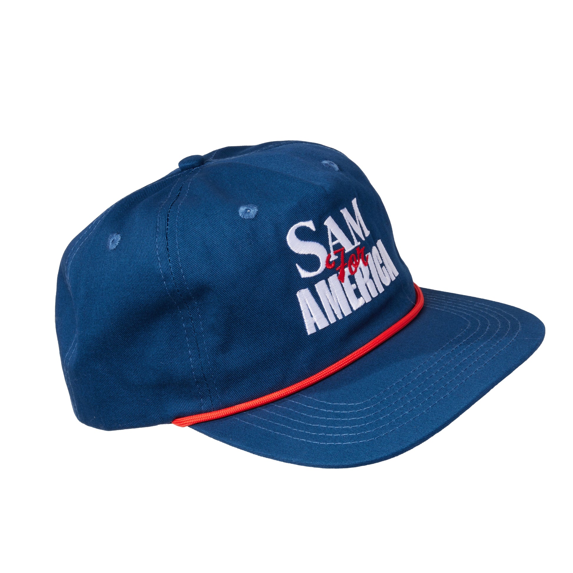 Side angle of navy blue Samuel Adams rope baseball hat showing white “Sam for America” embroidery and red rope trim along the flat brim
