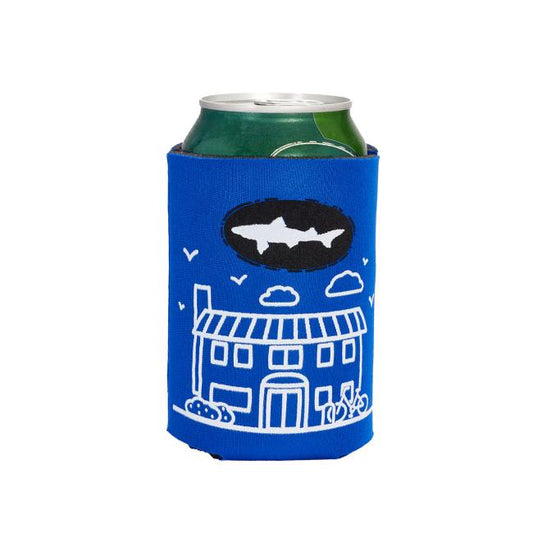 The INN 12oz Can Cooler by Grandstand Glassware & Apparel comes in blue with a white house and cloud illustration plus a black Dogfish Head INN logo with a white shark—ideal for keeping your craft beer chilled.