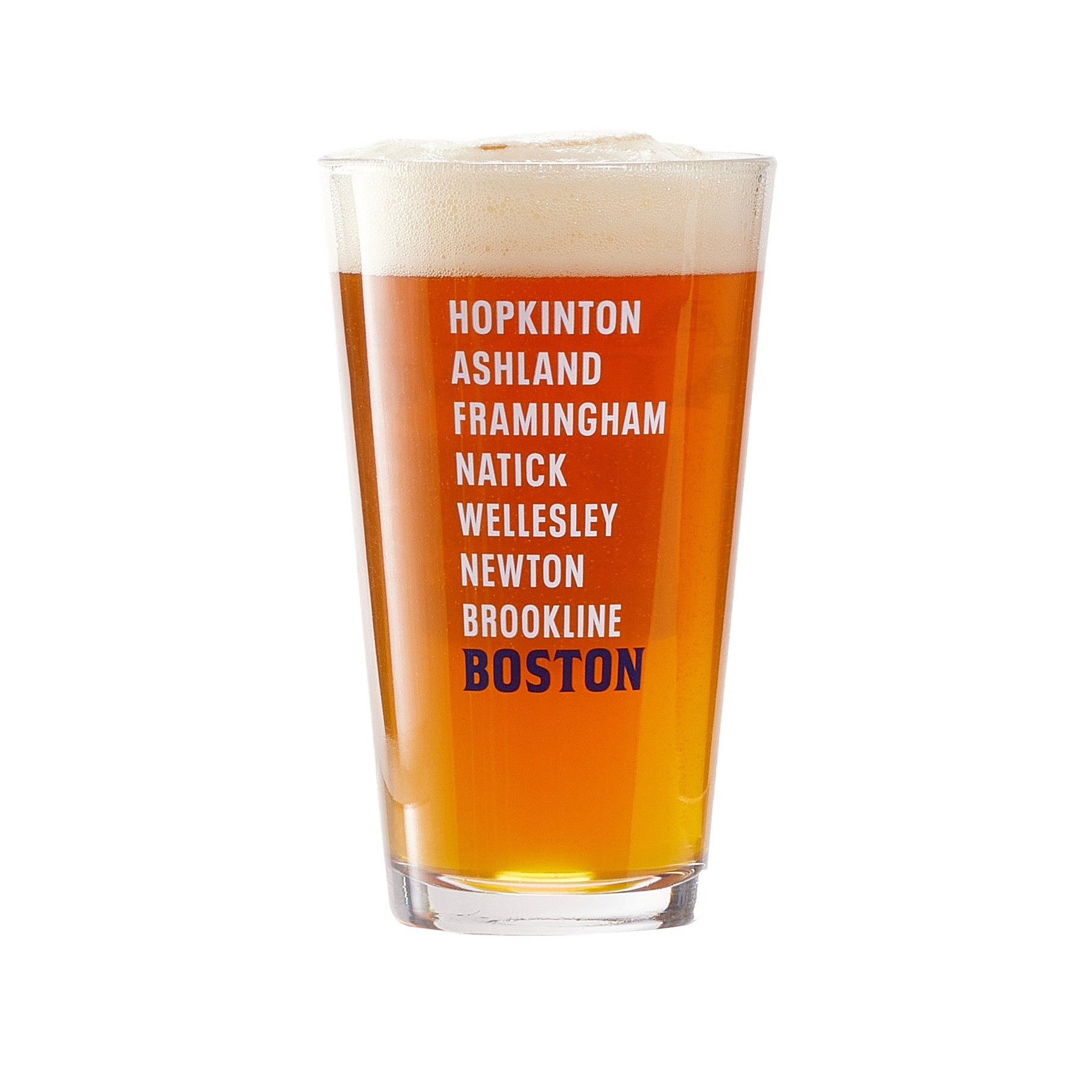 A pint glass filled with amber-colored beer topped with a foamy head. The glass features a vertical list of place names printed in bold white and dark blue text: “Hopkinton, Ashland, Framingham, Natick, Wellesley, Newton, Brookline, Boston.” The design references the towns along the Boston Marathon route.