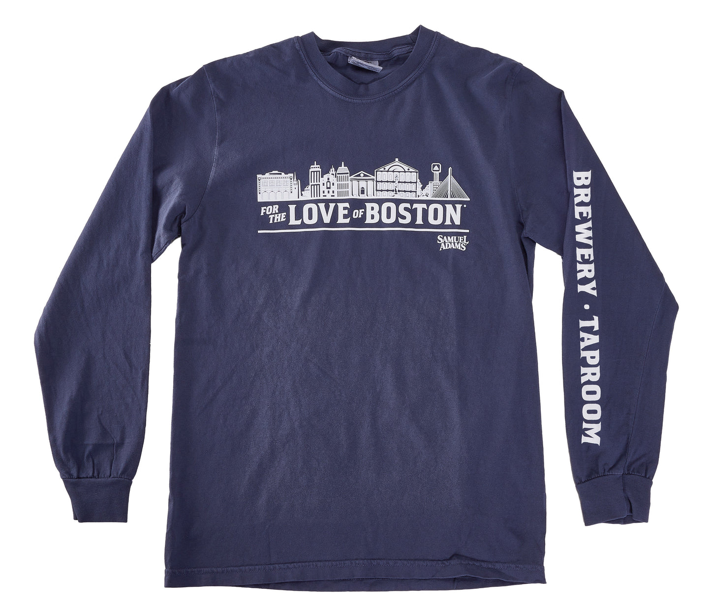 A navy blue long‑sleeve T‑shirt shown from the front. The chest displays a detailed white line‑art illustration of Boston landmarks above the phrase “FOR THE LOVE OF BOSTON,” with the Samuel Adams logo printed beneath it. The right sleeve features bold white vertical text reading “BREWERY · TAPROOM.” The shirt has ribbed cuffs and a classic crewneck collar