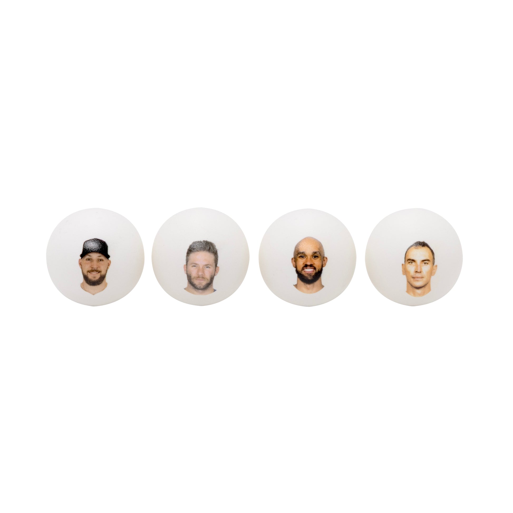 Four white ping pong balls with headshots .