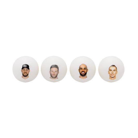 Four white ping pong balls with headshots .